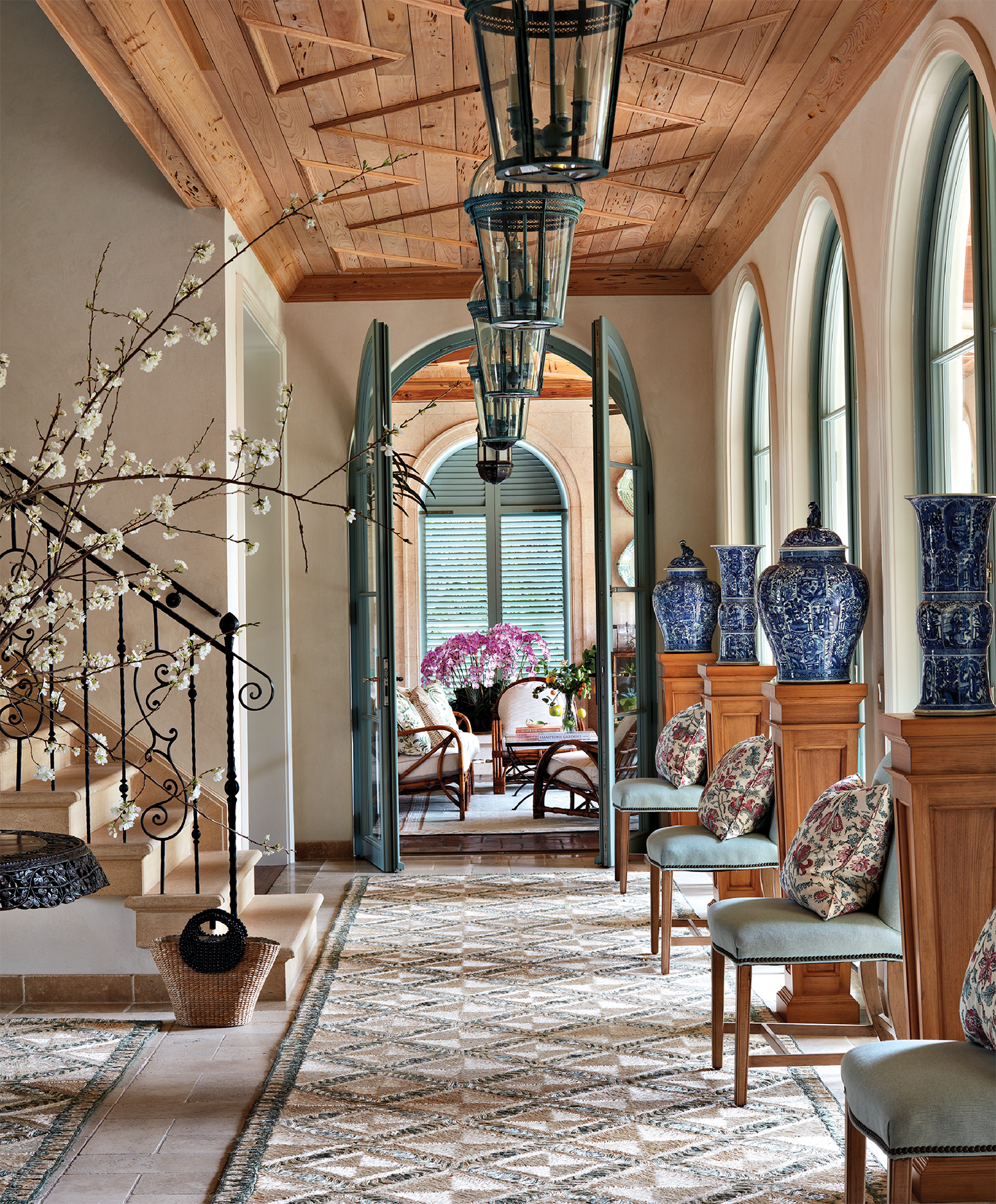 classic entryway with iron balustrades and cypress ceilings