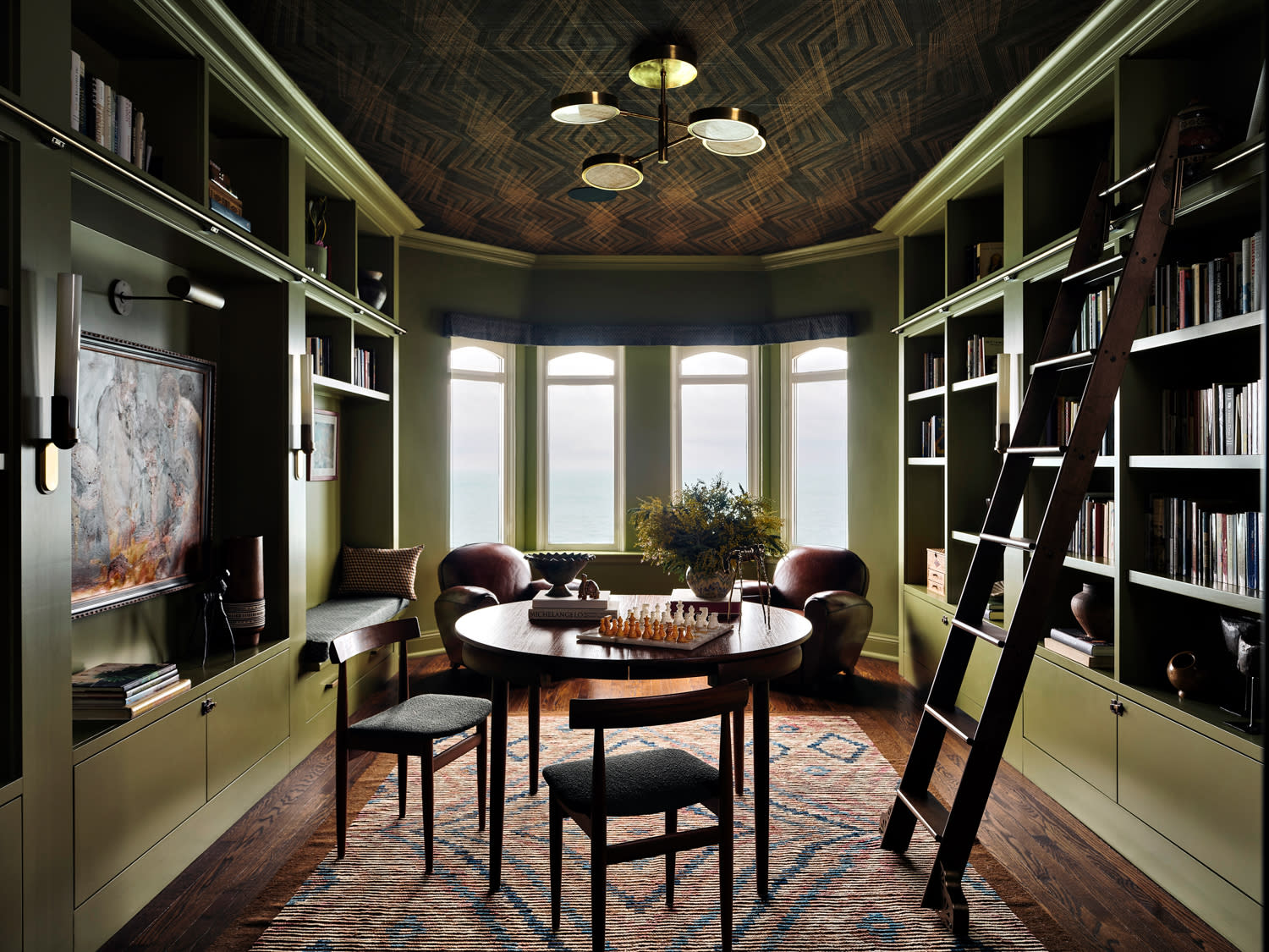 olive green home library with vintage furniture