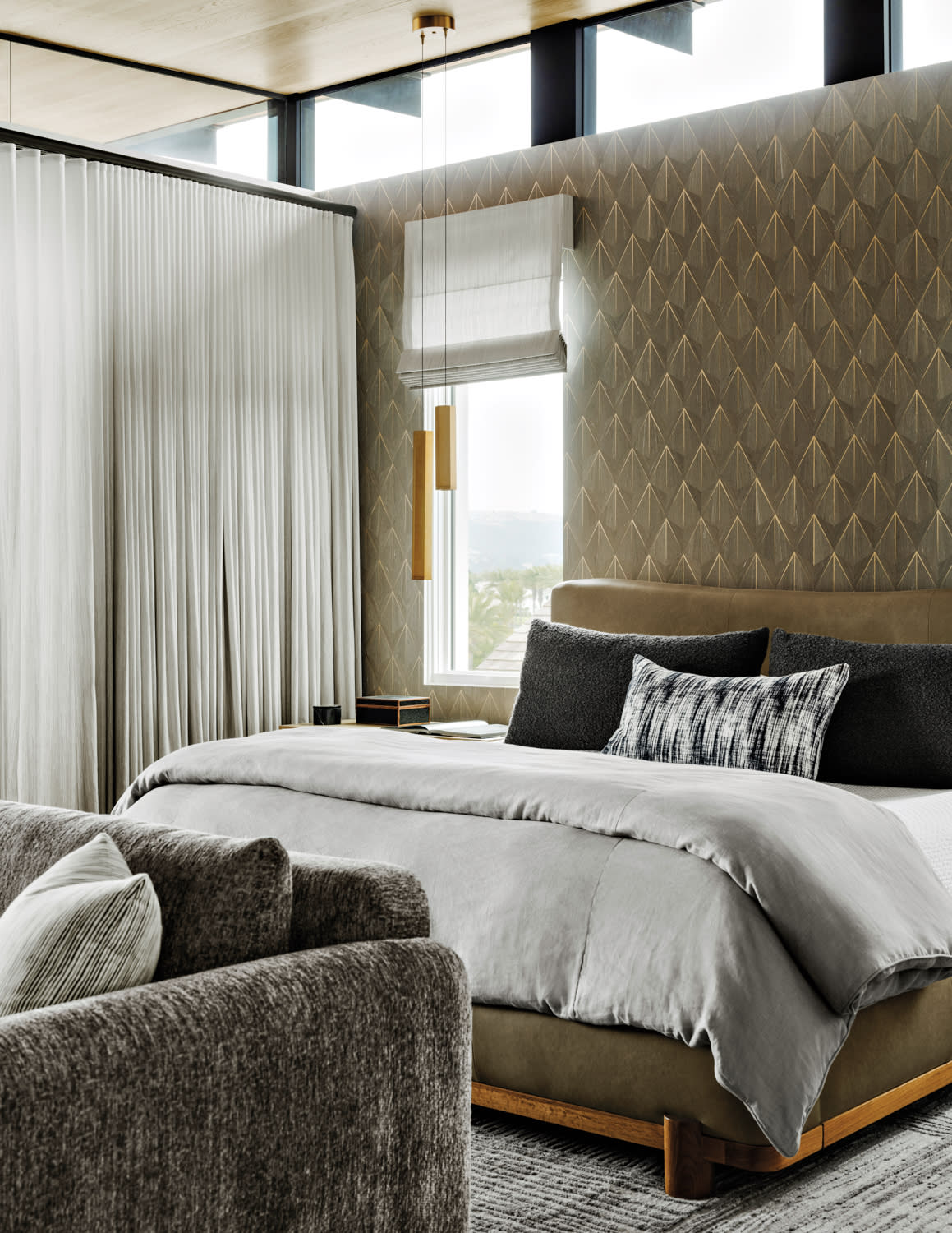 a shimmery wallcovering backs the bed in this modern primary suite