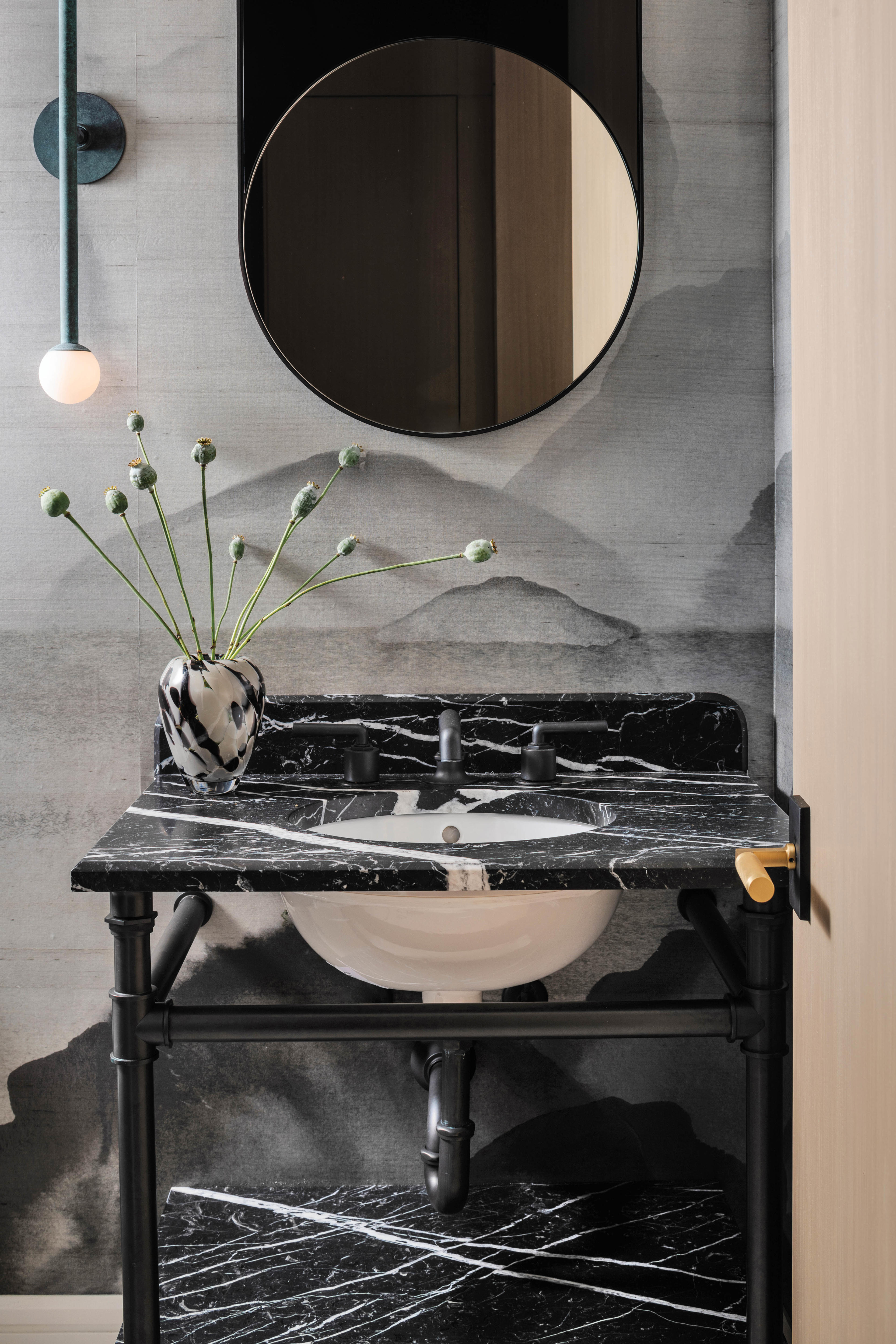 black marble wash basin in a moody bathroom