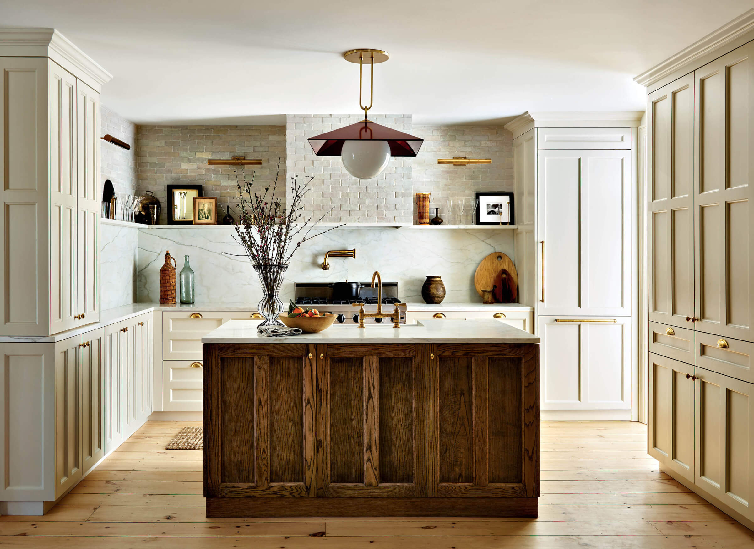 neutral kitchen with dark wood island and gold finishes