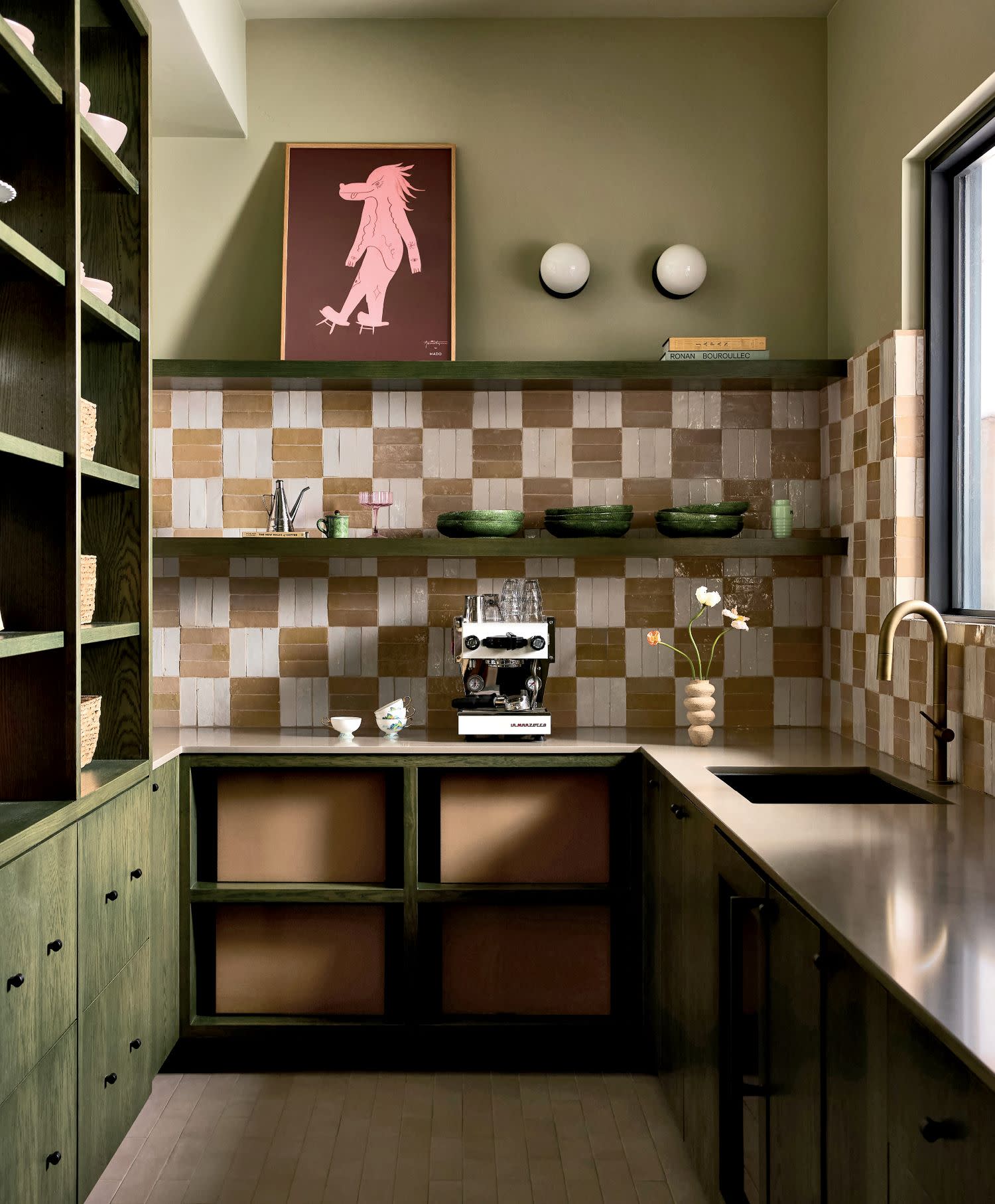 Cozy kitchen with olive-green cabinets, checkered tiles, and a warm, rustic feel