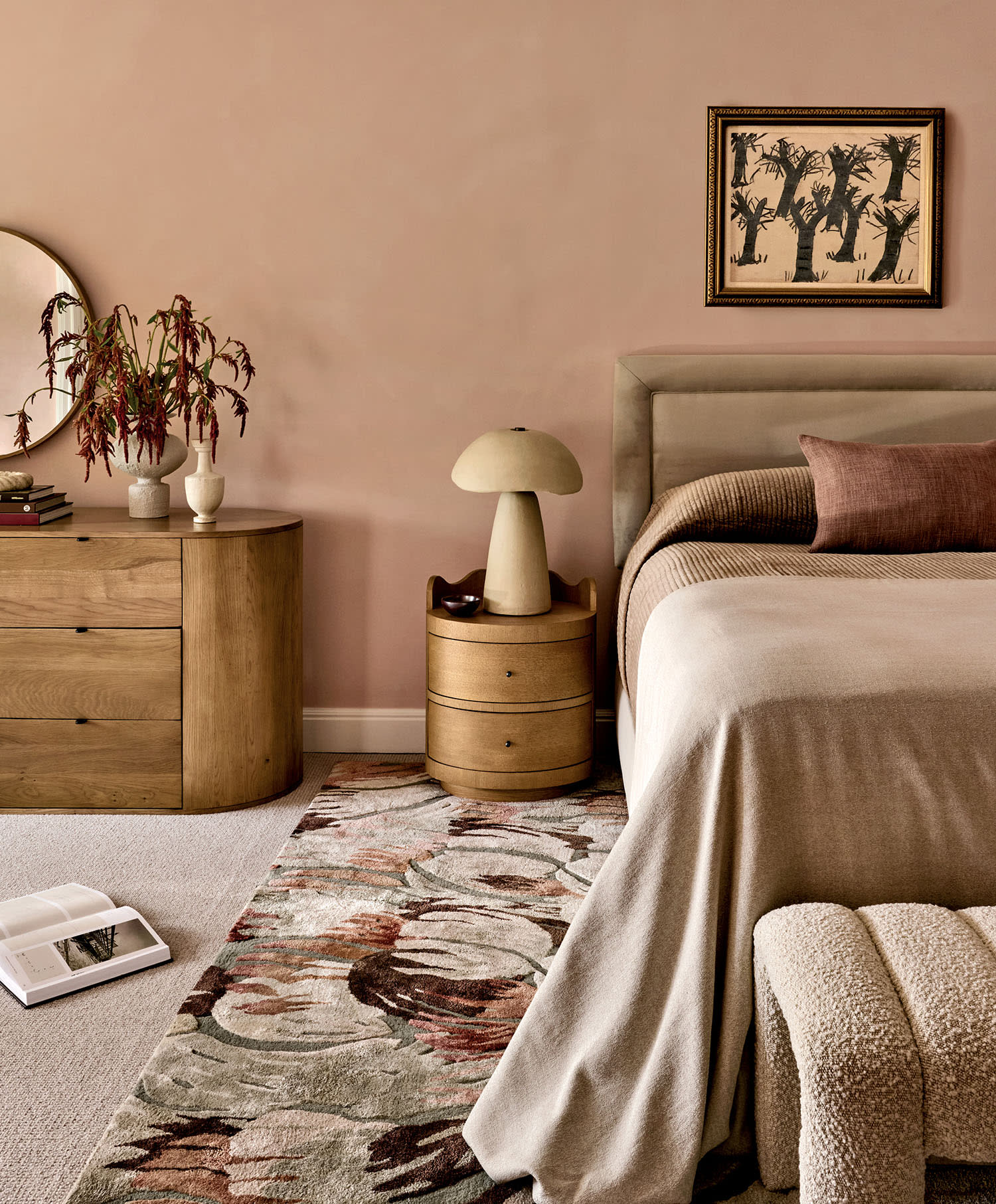 A cozy bedroom featuring a bed, a chair, and a decorative rug on the floor.