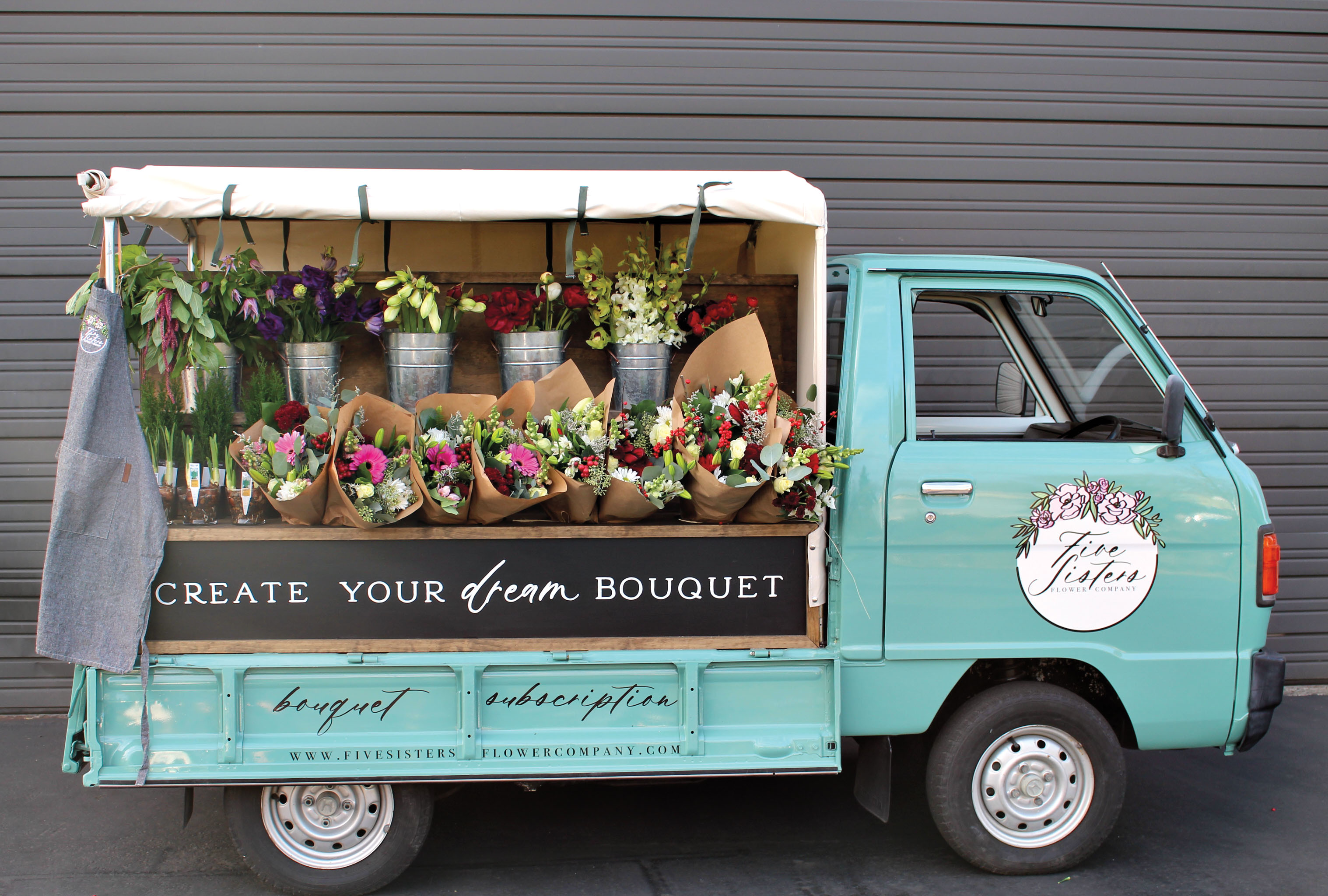 teal flower truck with bouquets