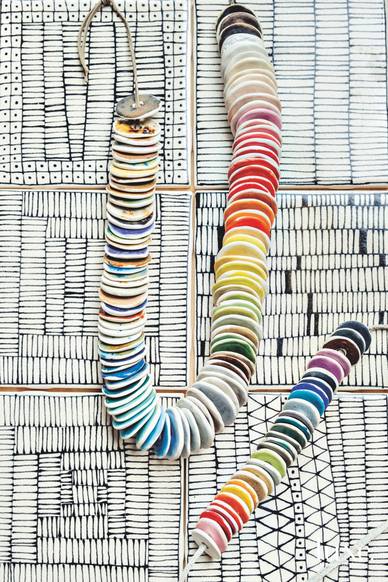 A strand of glaze samples upon her handmade tiles.