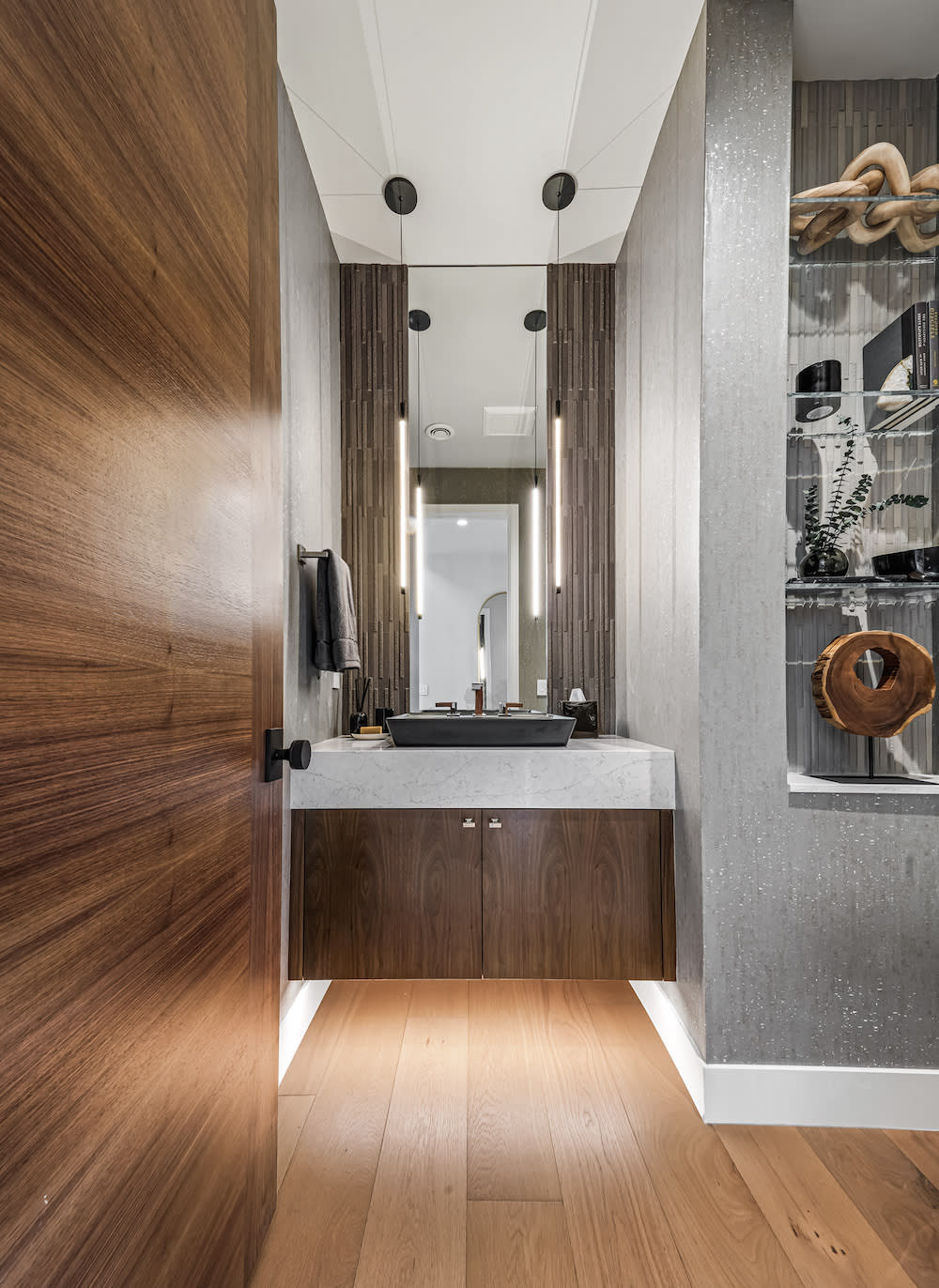 A bathroom featuring elegant wooden floors and a classic wooden door, creating a warm and inviting atmosphere.