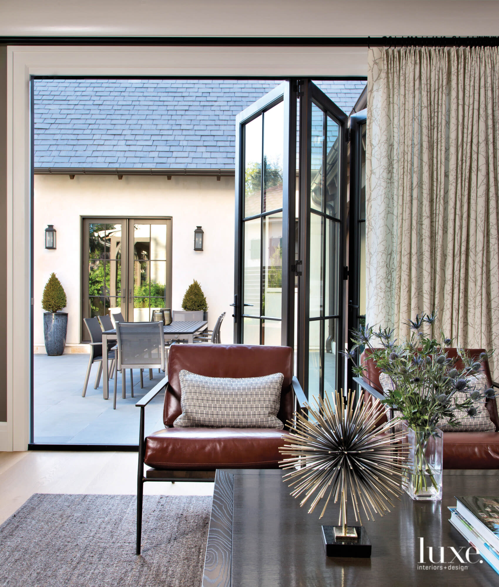 living room with leather chair and folding according door