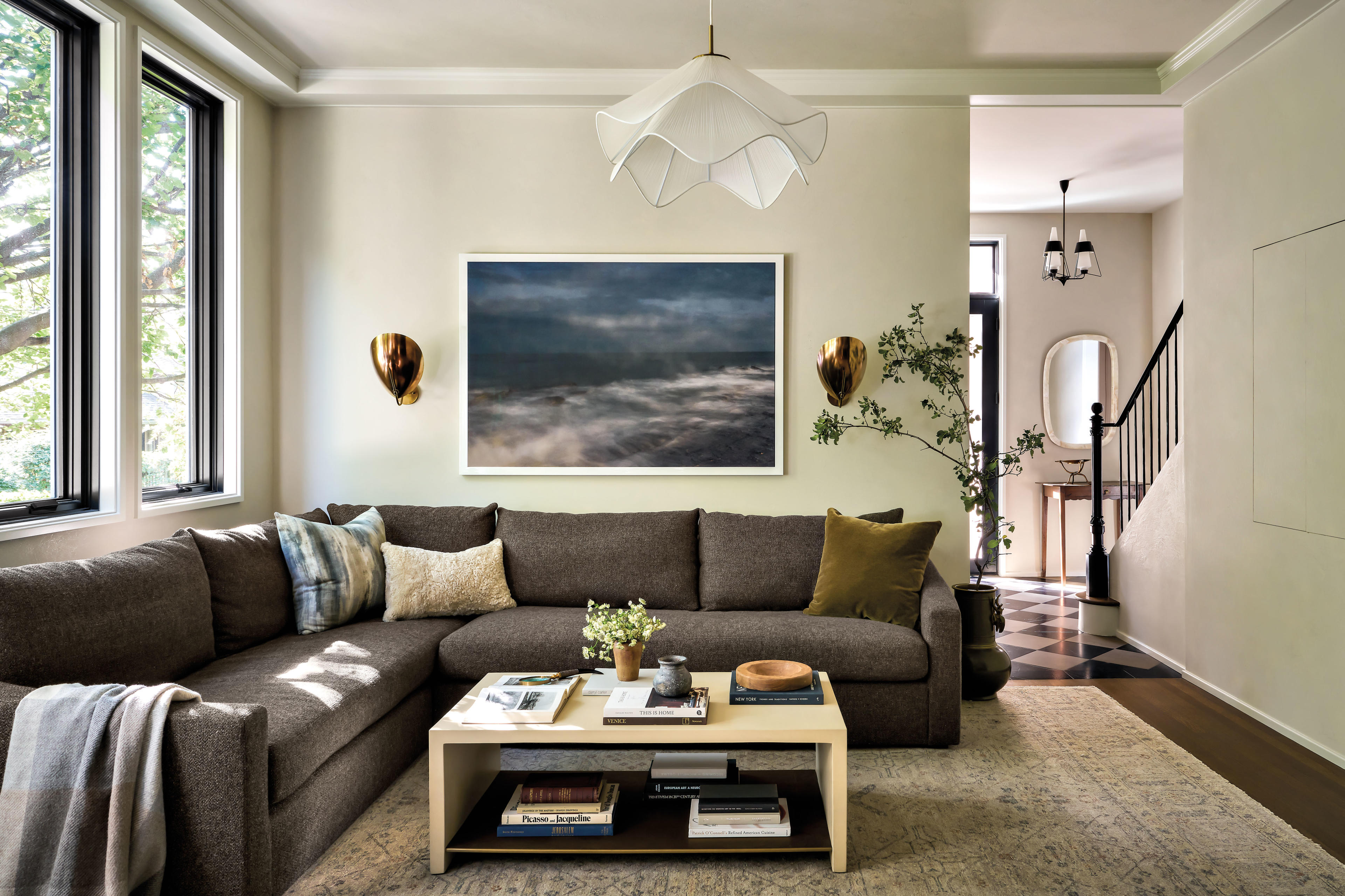 cozy family room with a brown sofa and a petaled light fixture