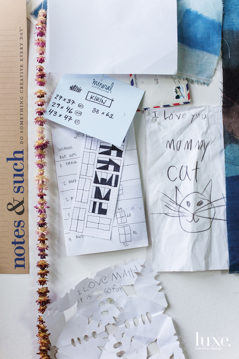 On the studio wall are notes and sketches providing inspiration and encouragement.