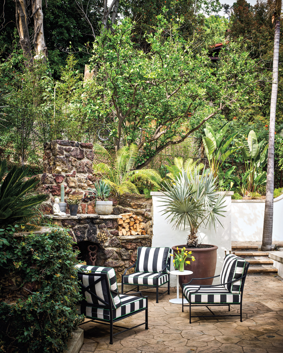 striped outdoor chairs around fireplace
