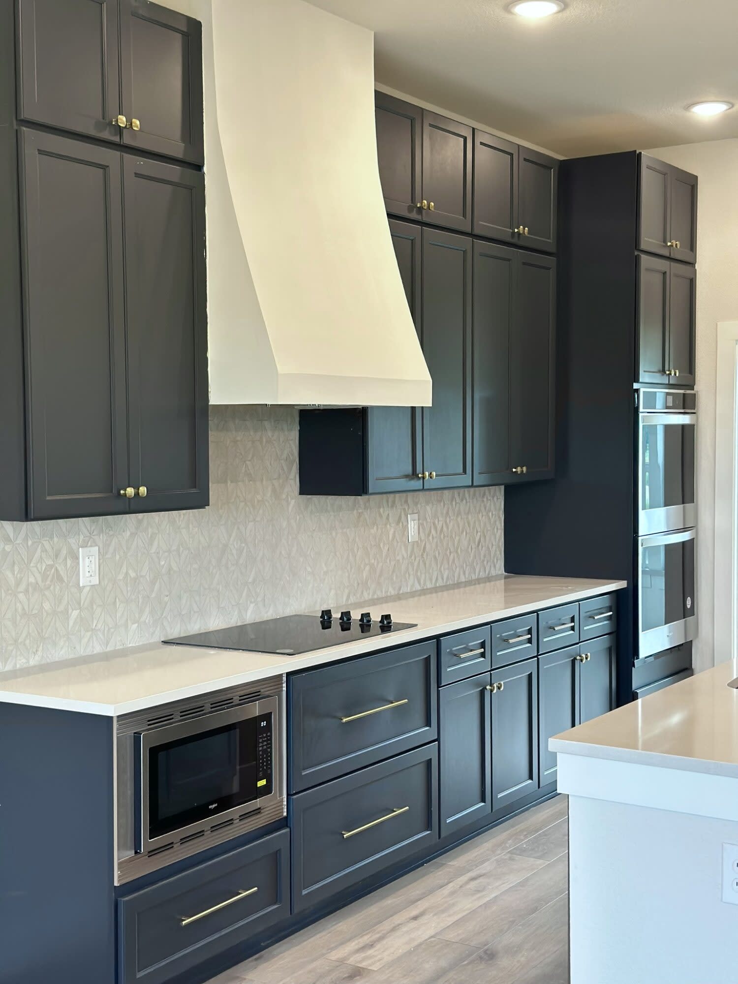 Blue cabinets contrast with white countertops in a modern kitchen.