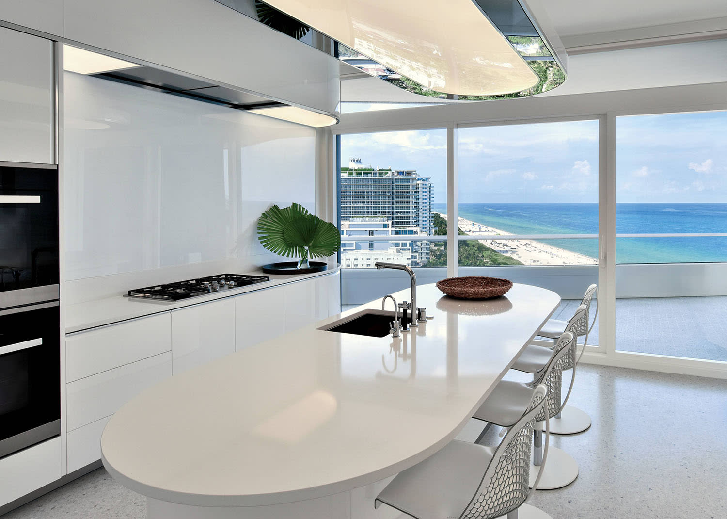 white kitchen with quartz countertops and oceanfront views