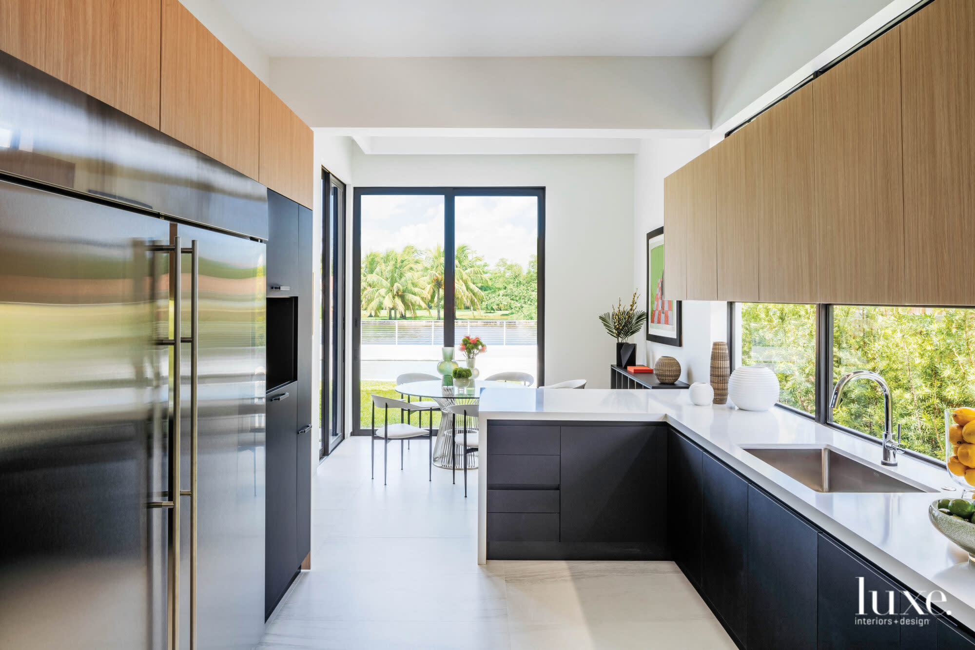 Kitchen with white oak and black-lacquered cabinetry.