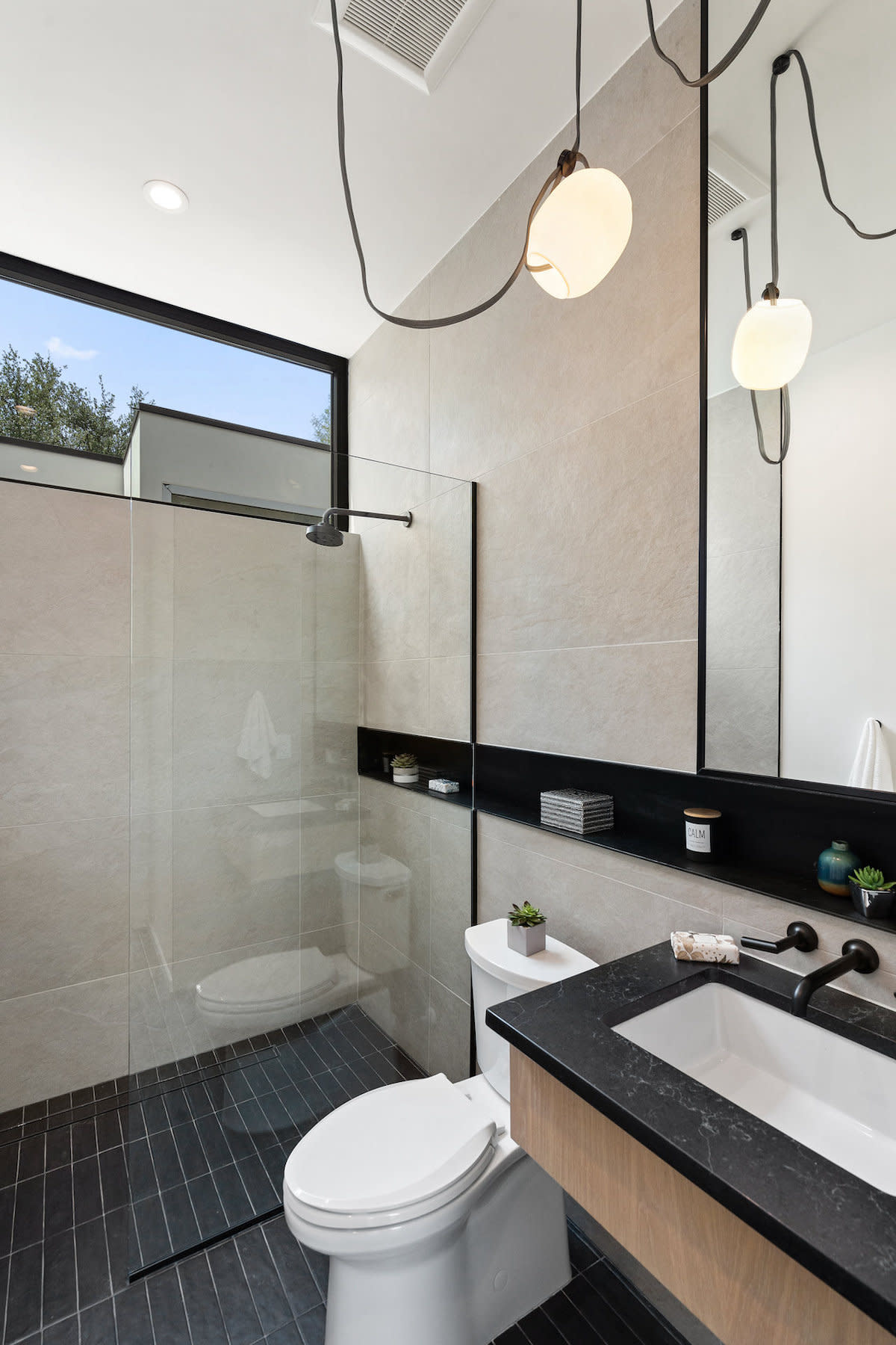 A contemporary bathroom featuring a stylish black and white tiled design.