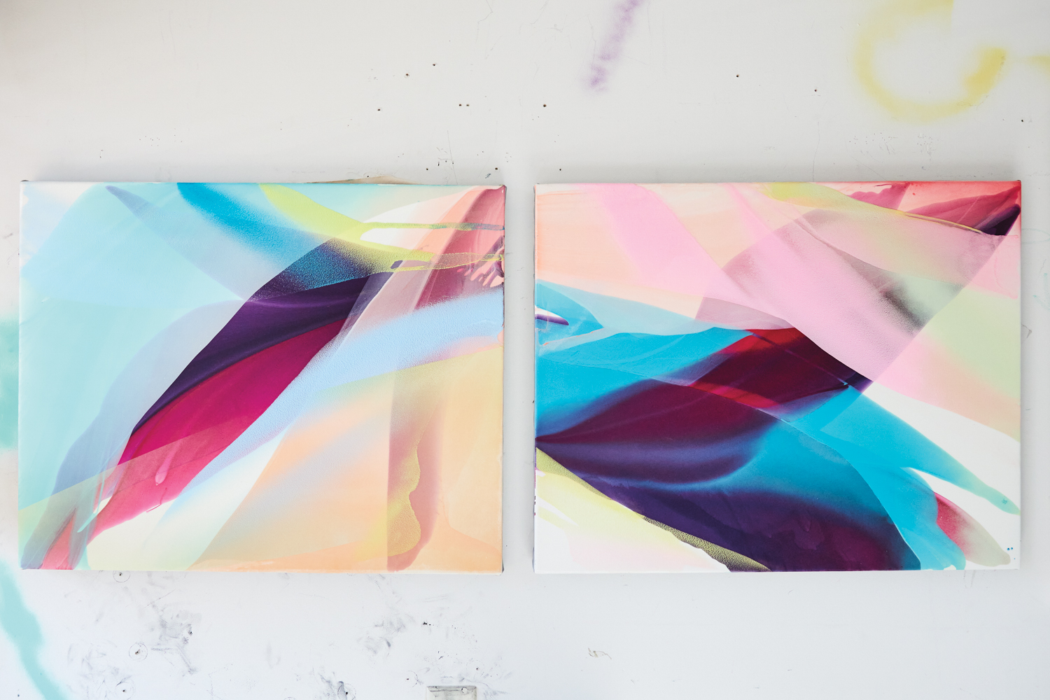 A pair of colorful, abstract canvases placed side by side