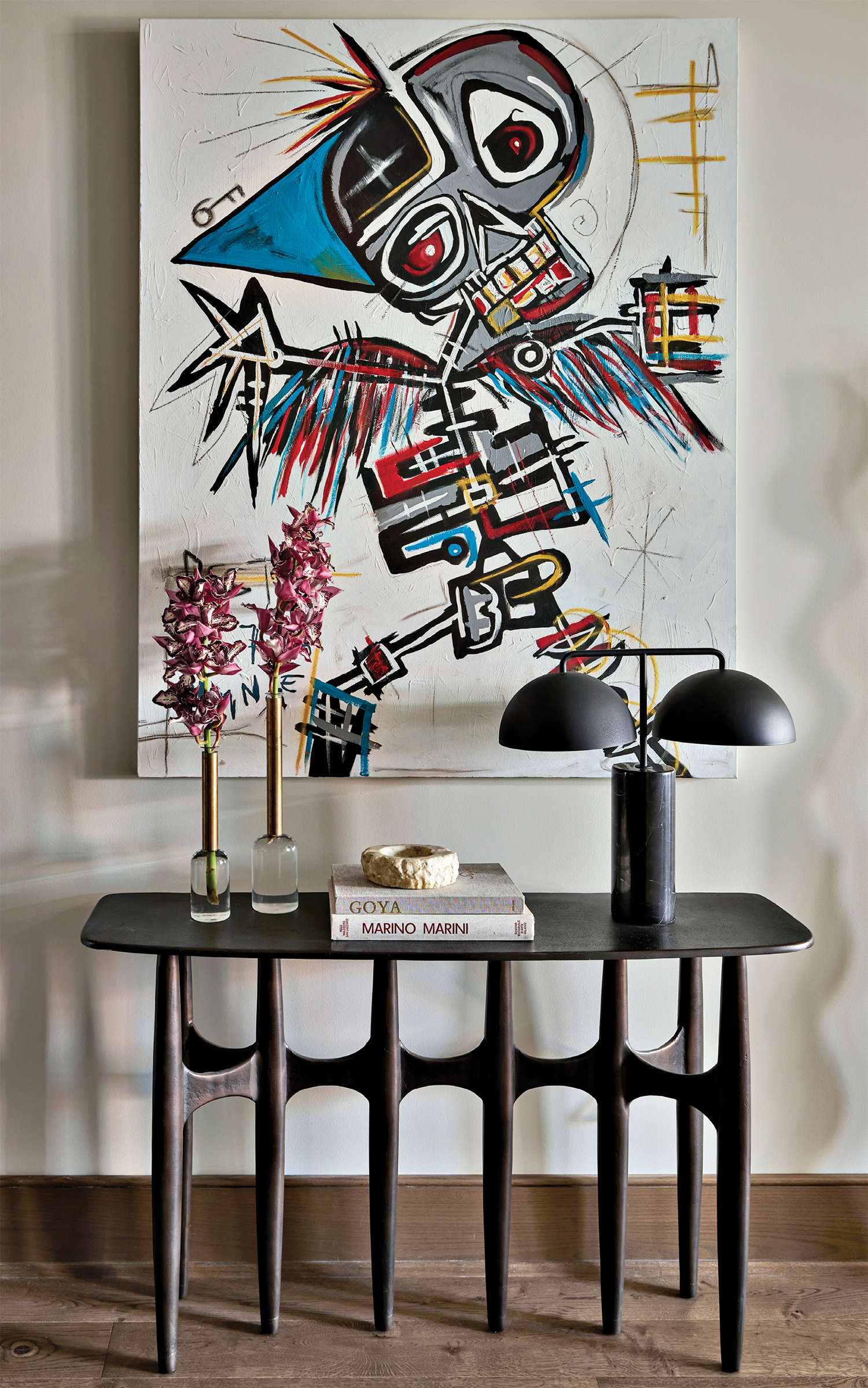 modern graphic artwork above a sculptural console table in the hallway of a Illinois home