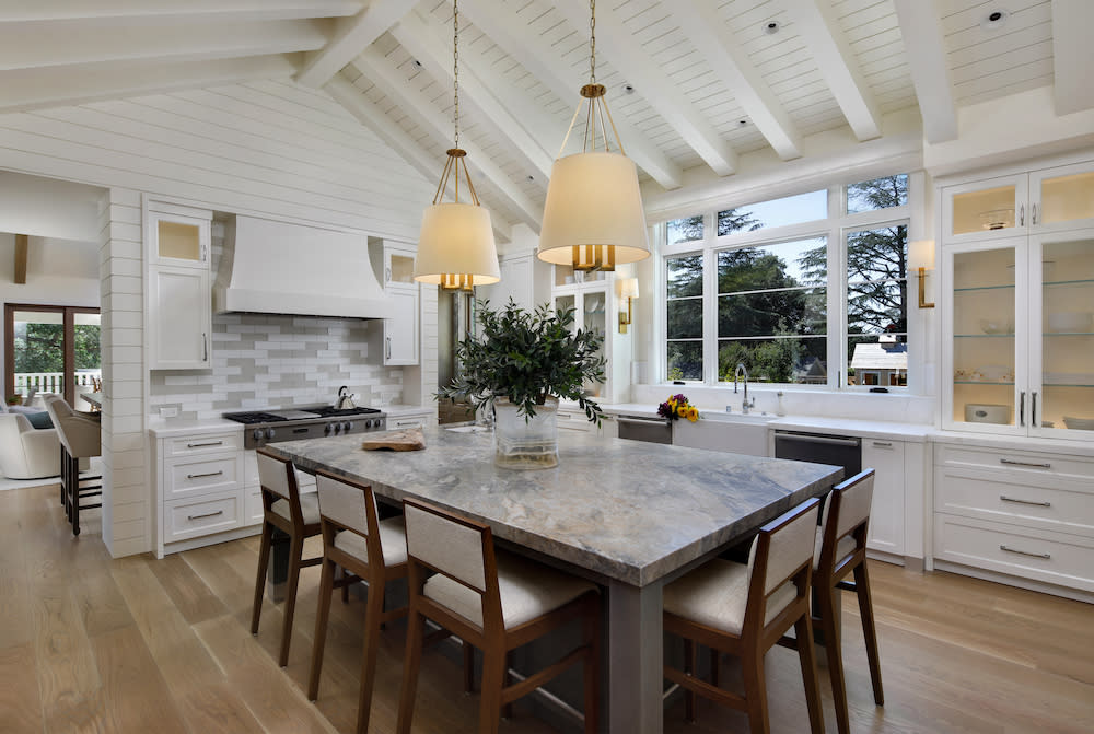 traditional kitchen with wood beams on ceiling and hard wood floors in Northern California home by De Mattei Construction