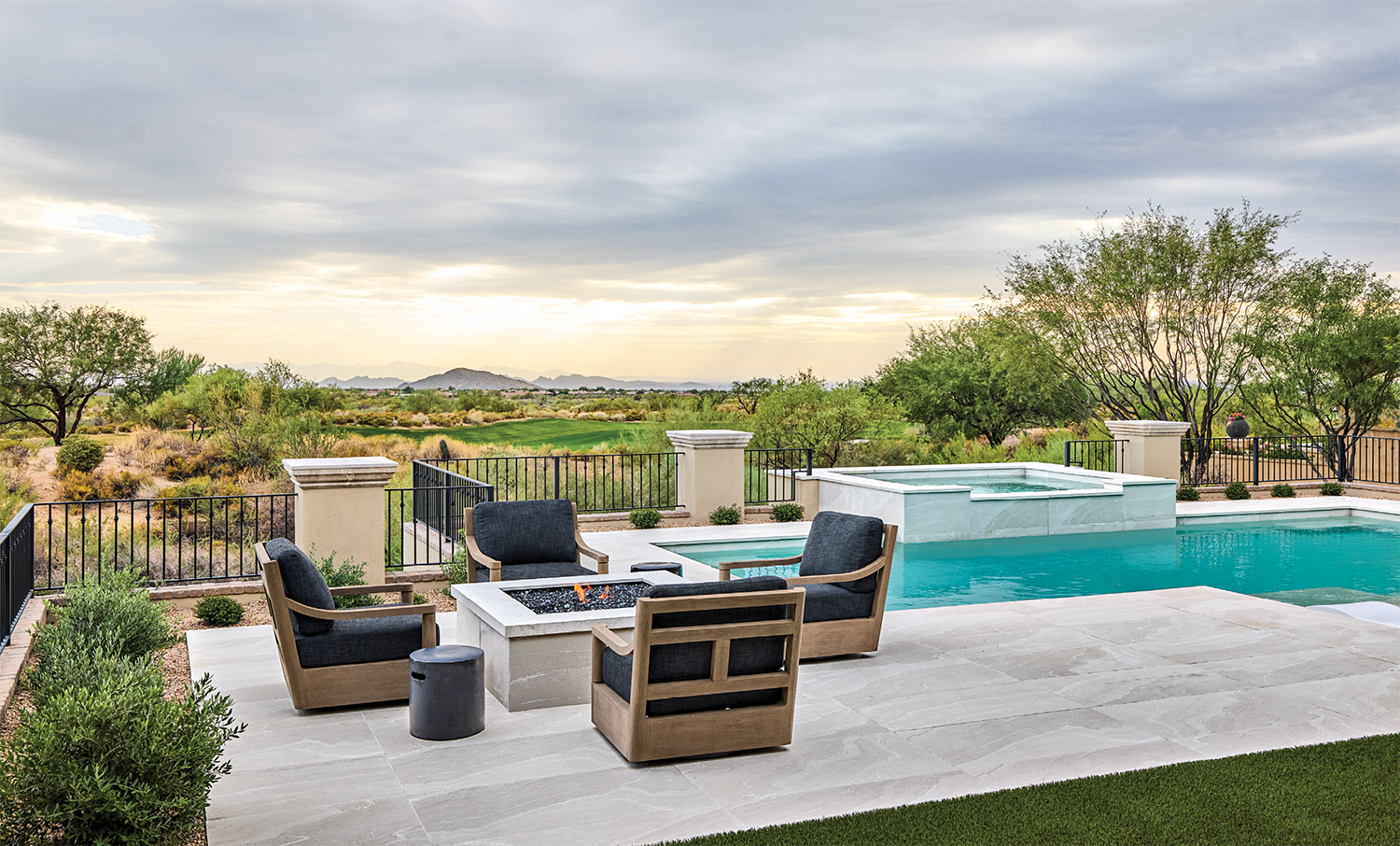 back exterior of an Arizona vacation home with a pool overlooking desert landscape