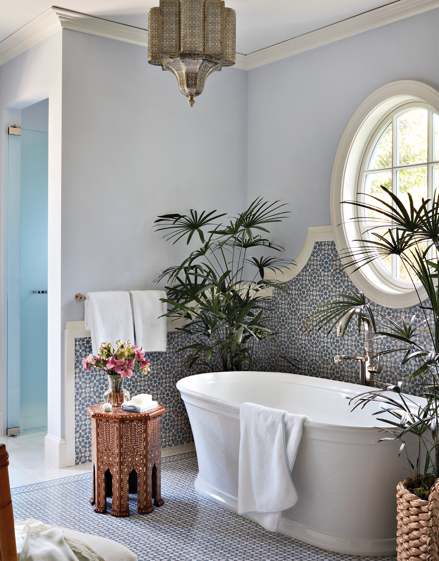 European-inspired bathroom with a port window above the tub