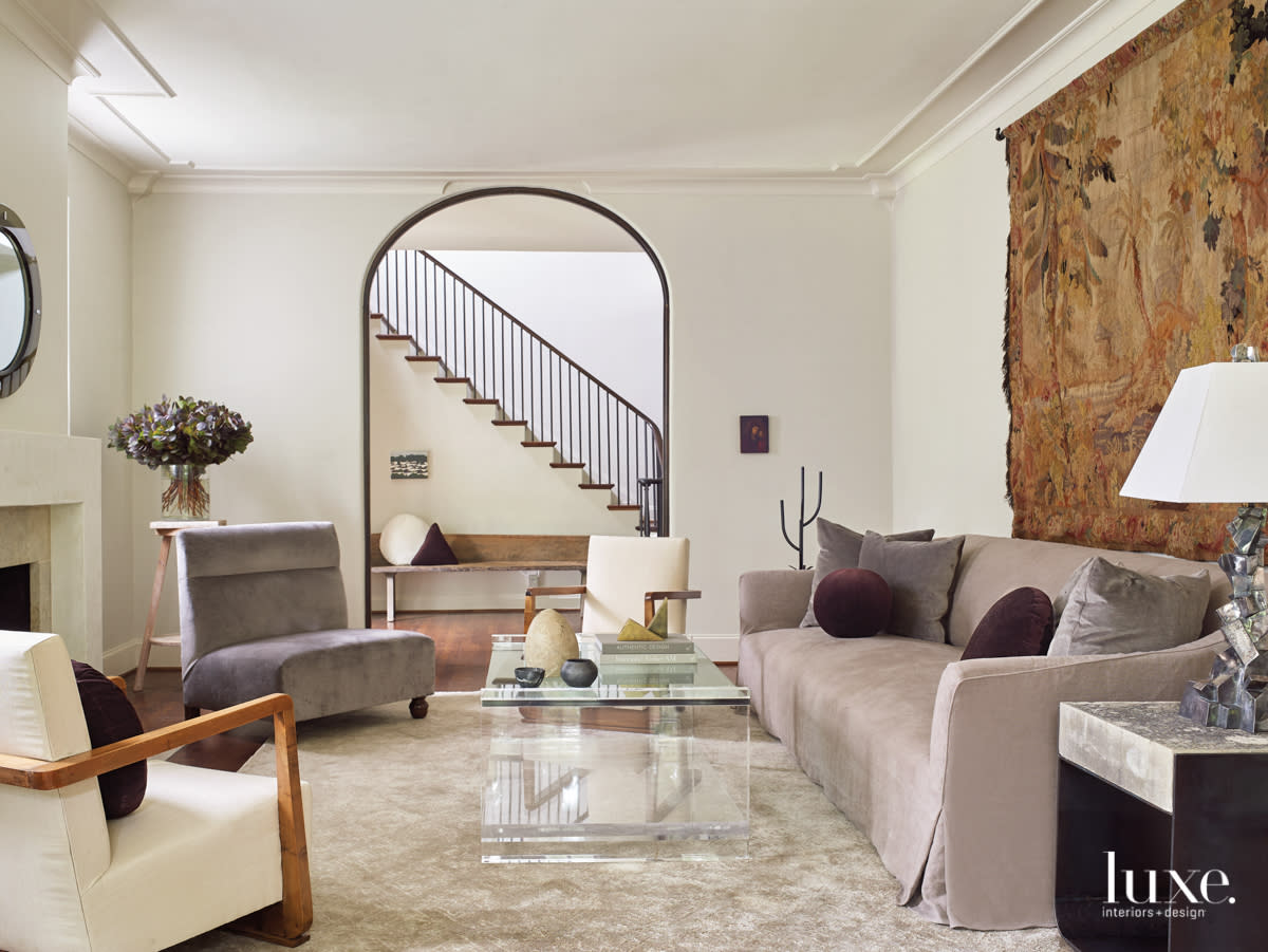 A formal living room's eclectic mix of furnishings including a custom Belgian-style sofa and velvet-upholstered slipper chair