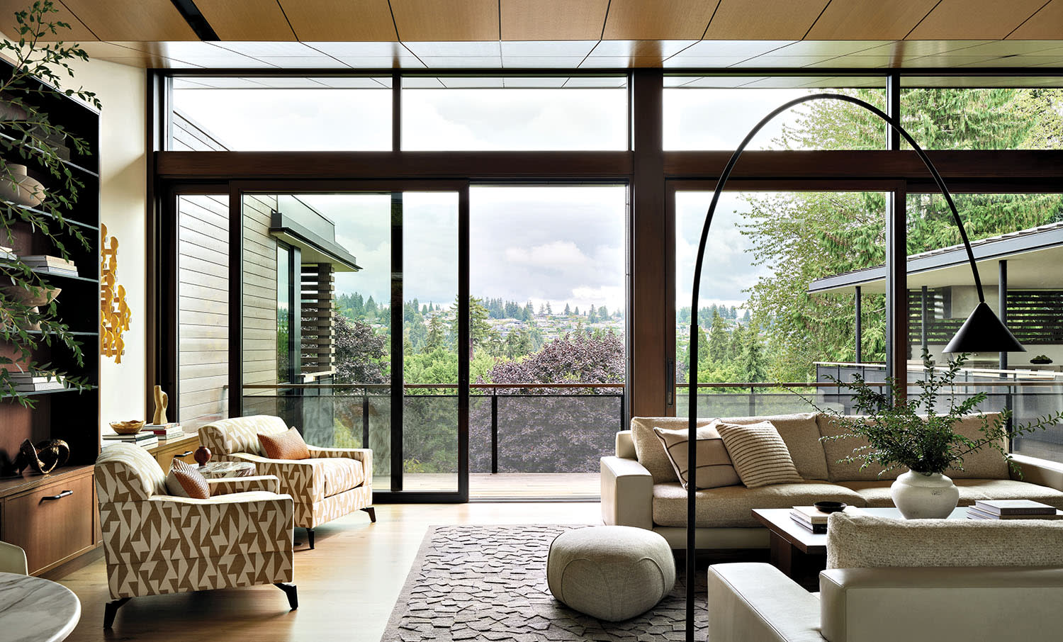 set of armchairs in a seating area in a glass-walled living room