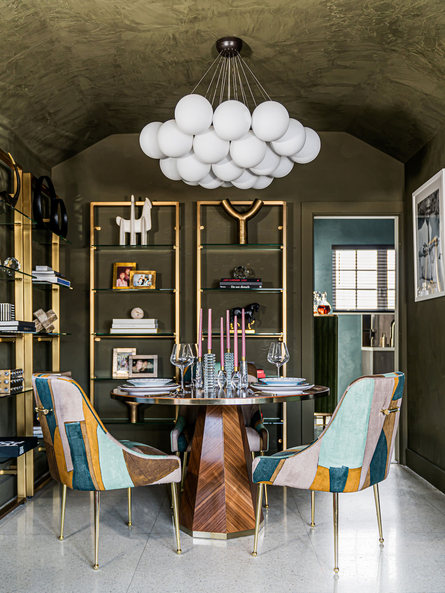 modern artful dining space with bubble chandelier by travis london