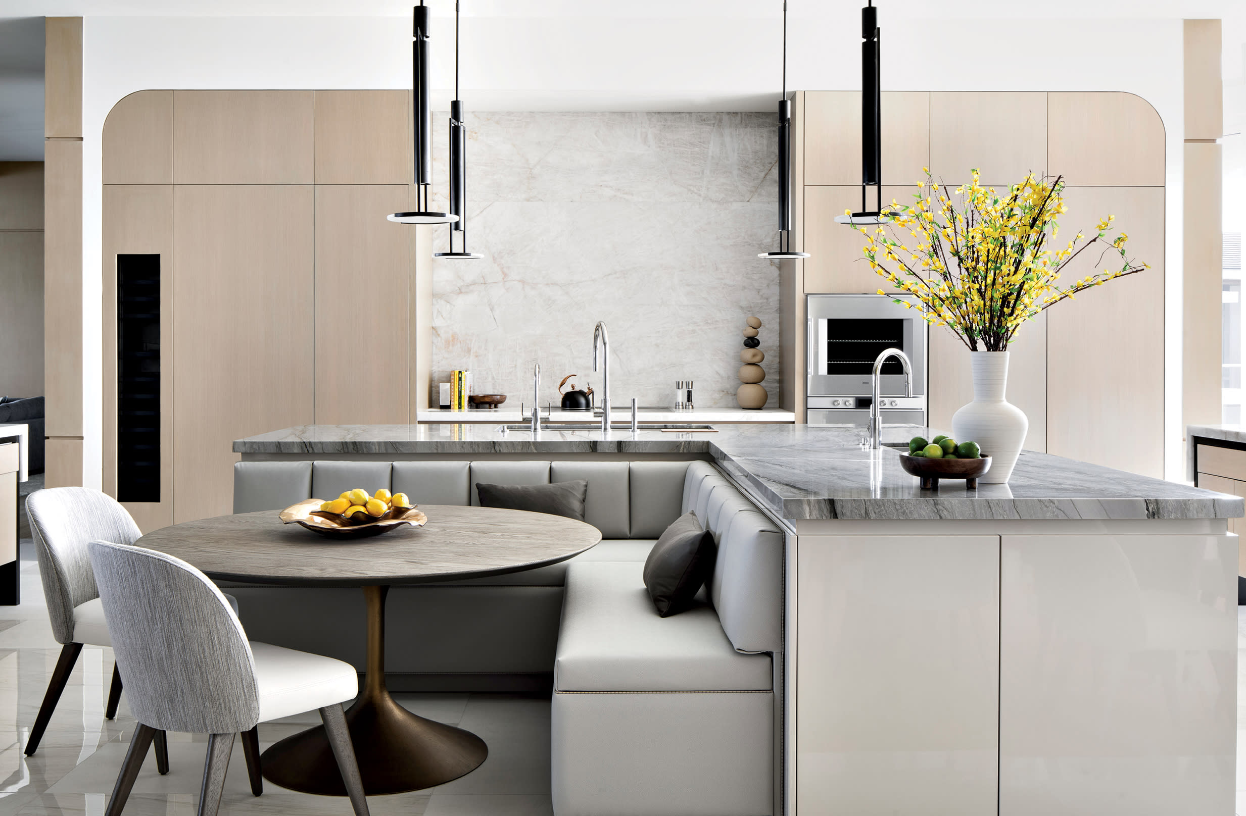 neutral kitchen with a dining nook alongside an L-shaped island