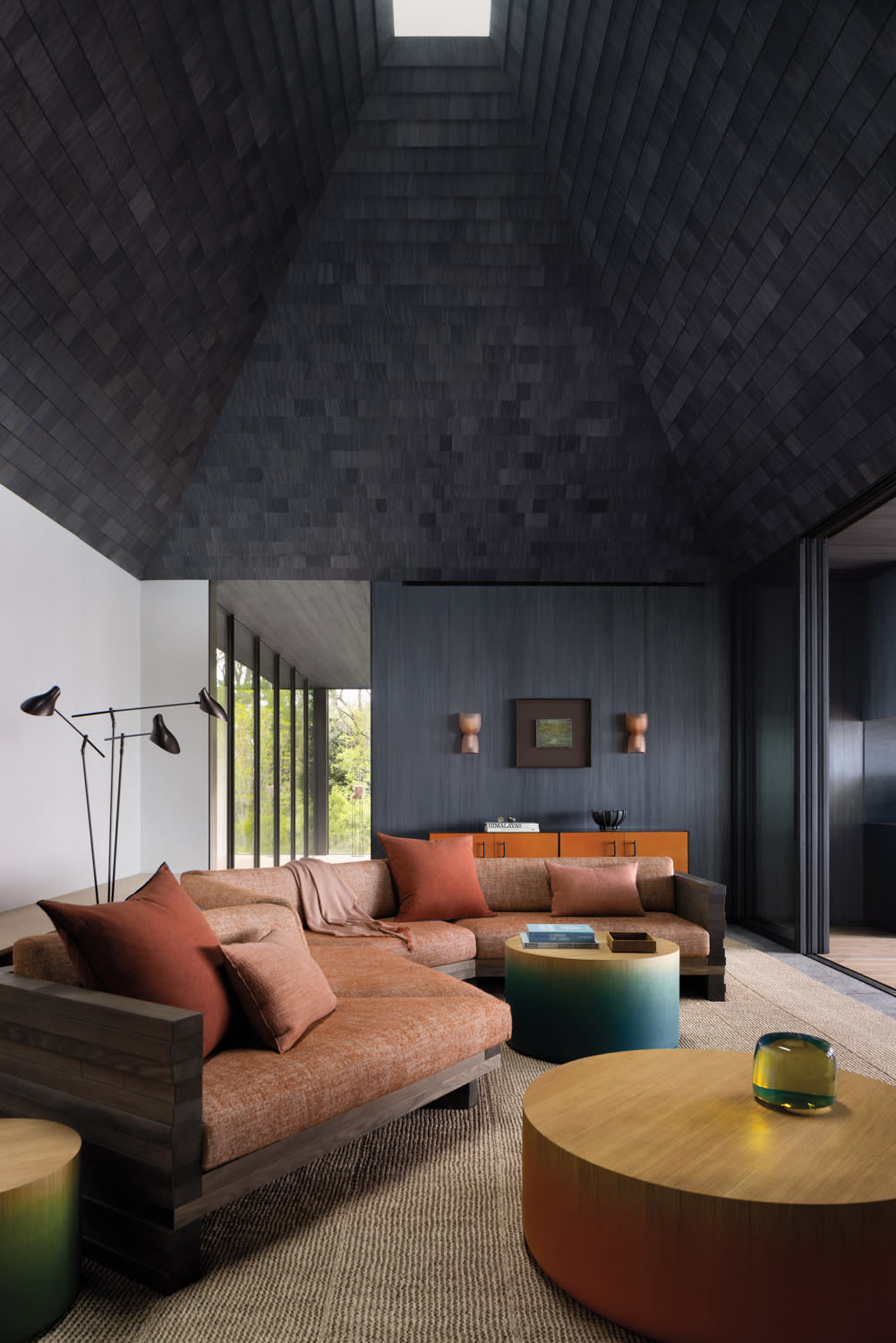 warm tone furnishings inside a family room with gray-black walls