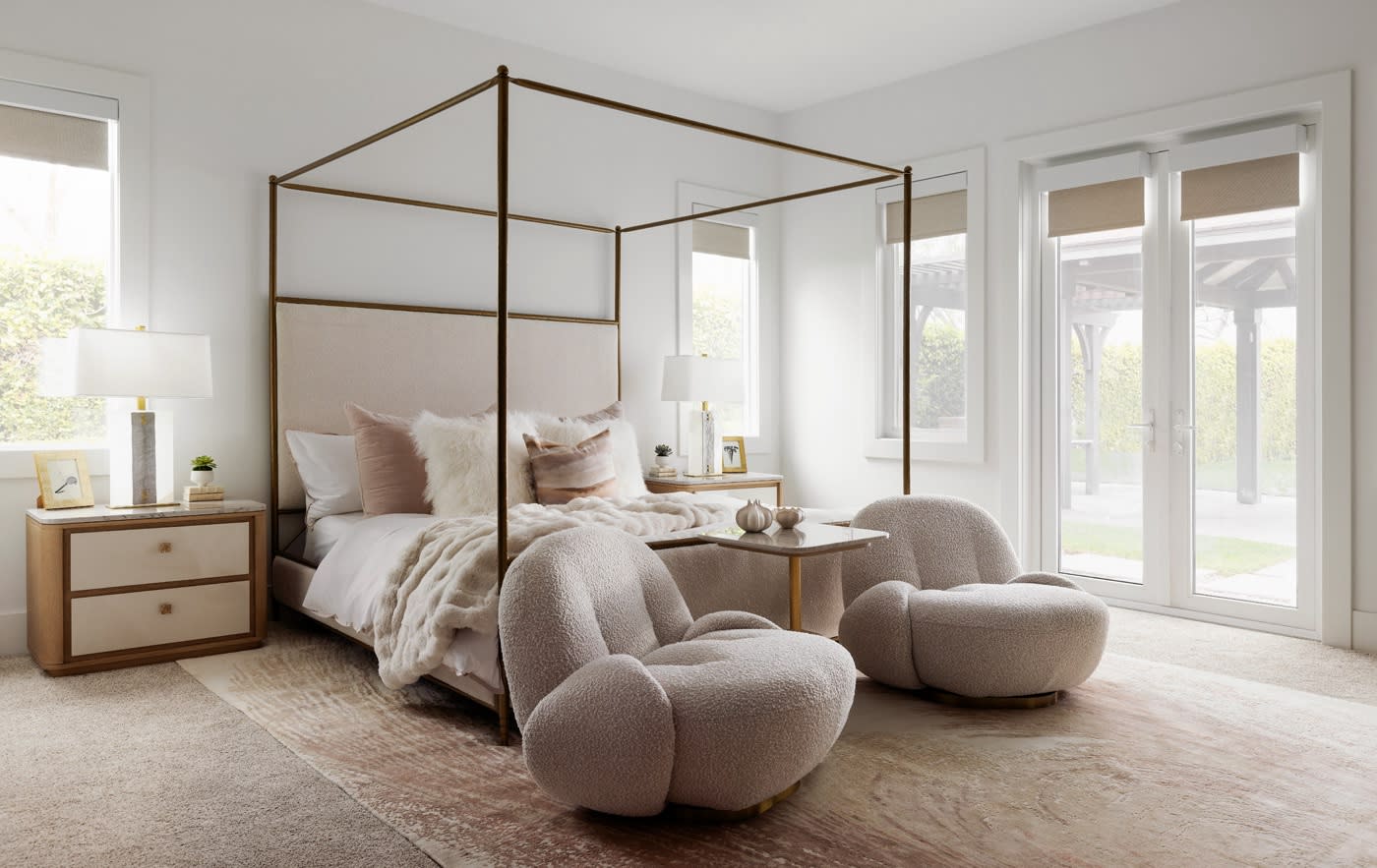 A serene bedroom showcasing a canopy bed and two chairs, designed for relaxation and comfort.