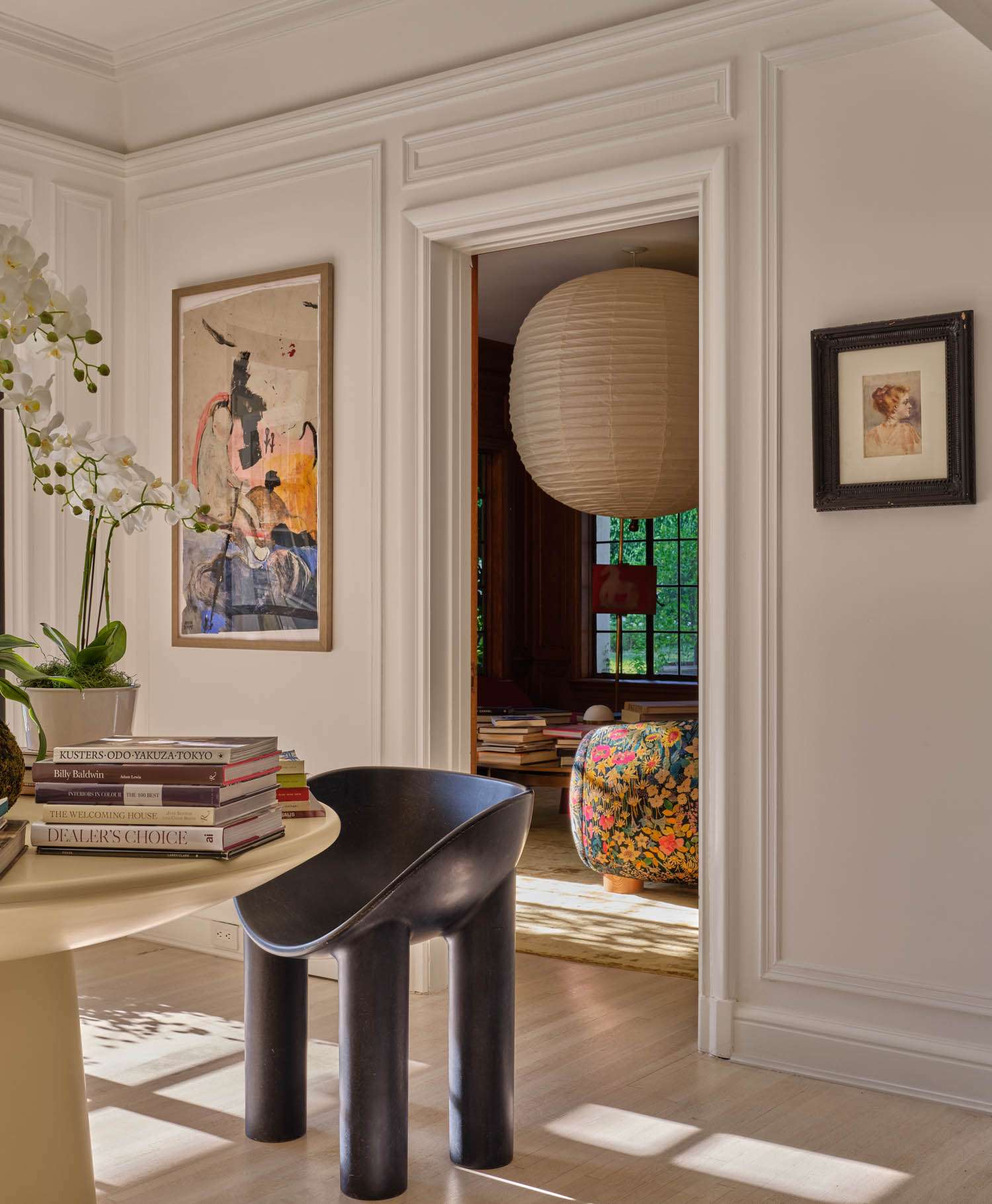 large hanging lantern is seen through the doorway of a sitting room