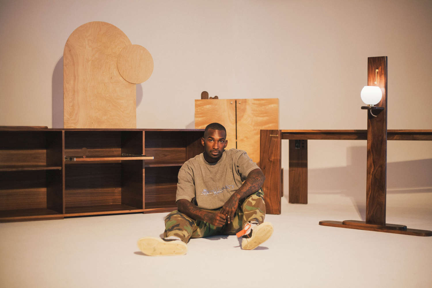 Robby Simon sits in front of his woodworking creations of various hardwoods.