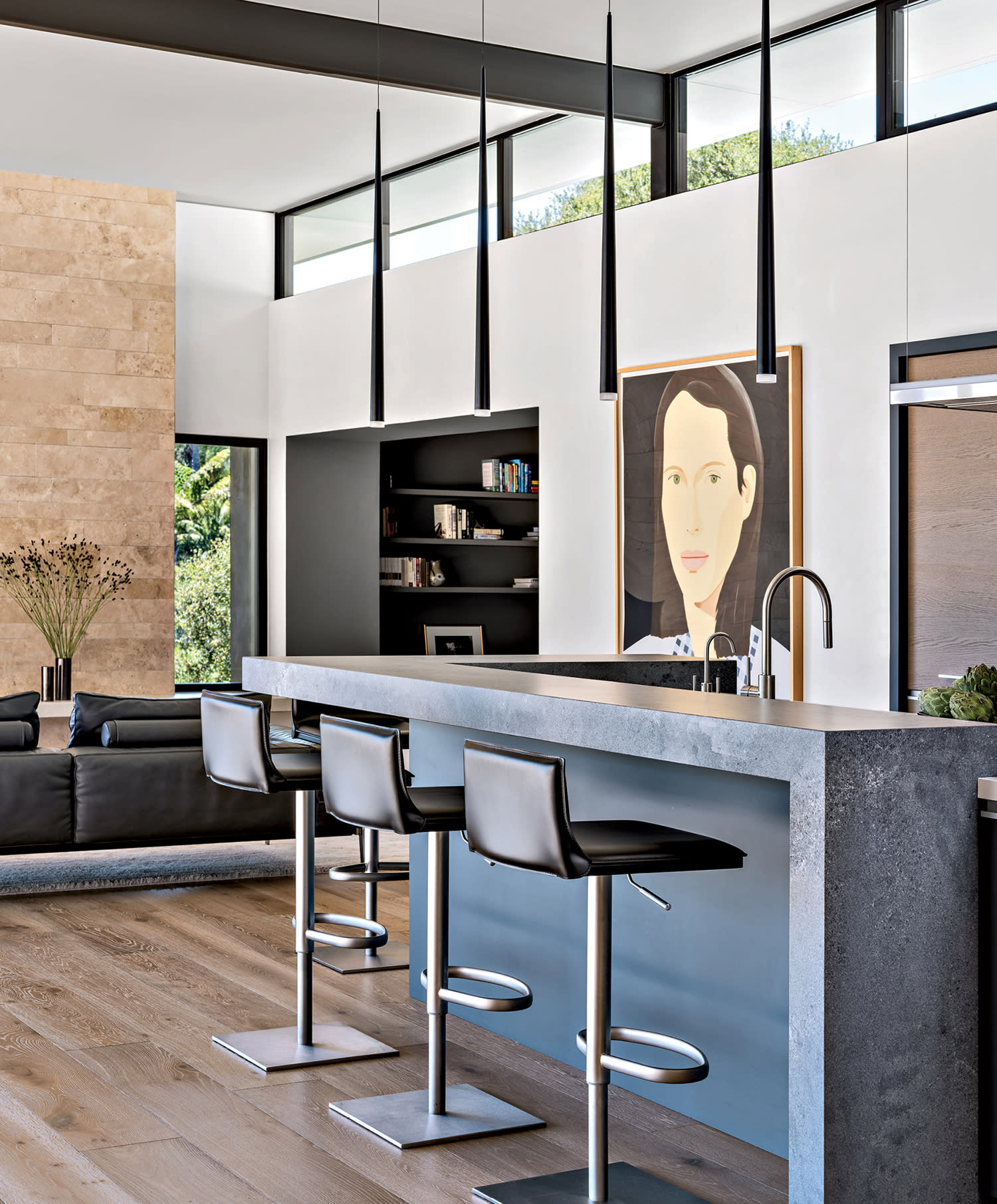 dark gray kitchen island in an open concept kitchen and living room with an Alex Katz portrait