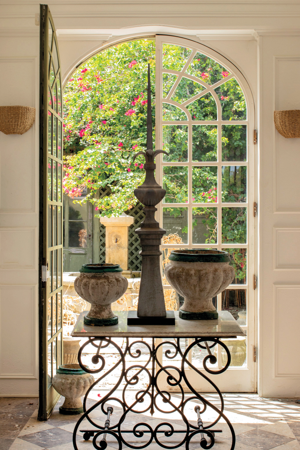 table by door with three antique vases