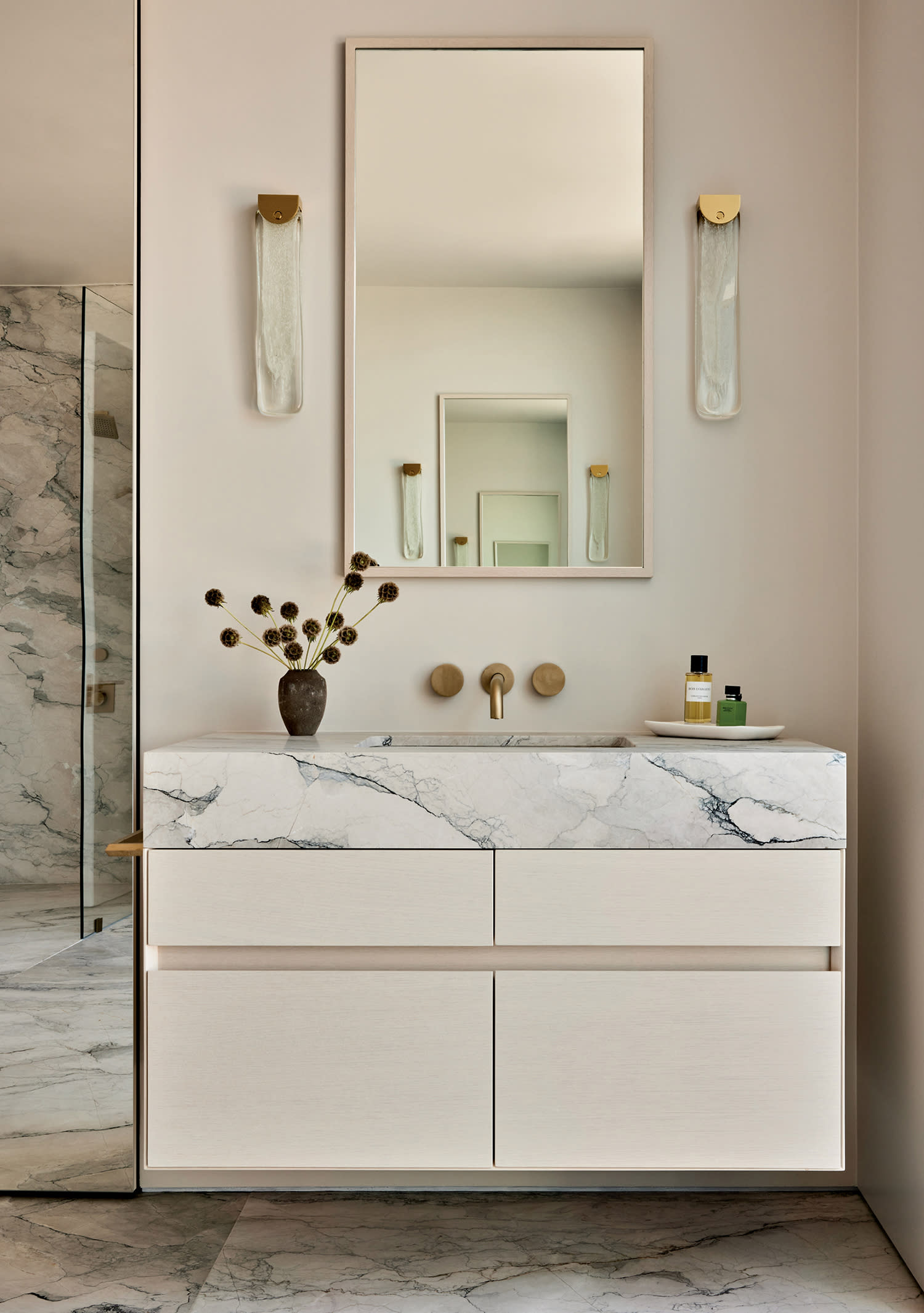 light and bright modern bathroom with truffle marble slabs on the vanity and floor