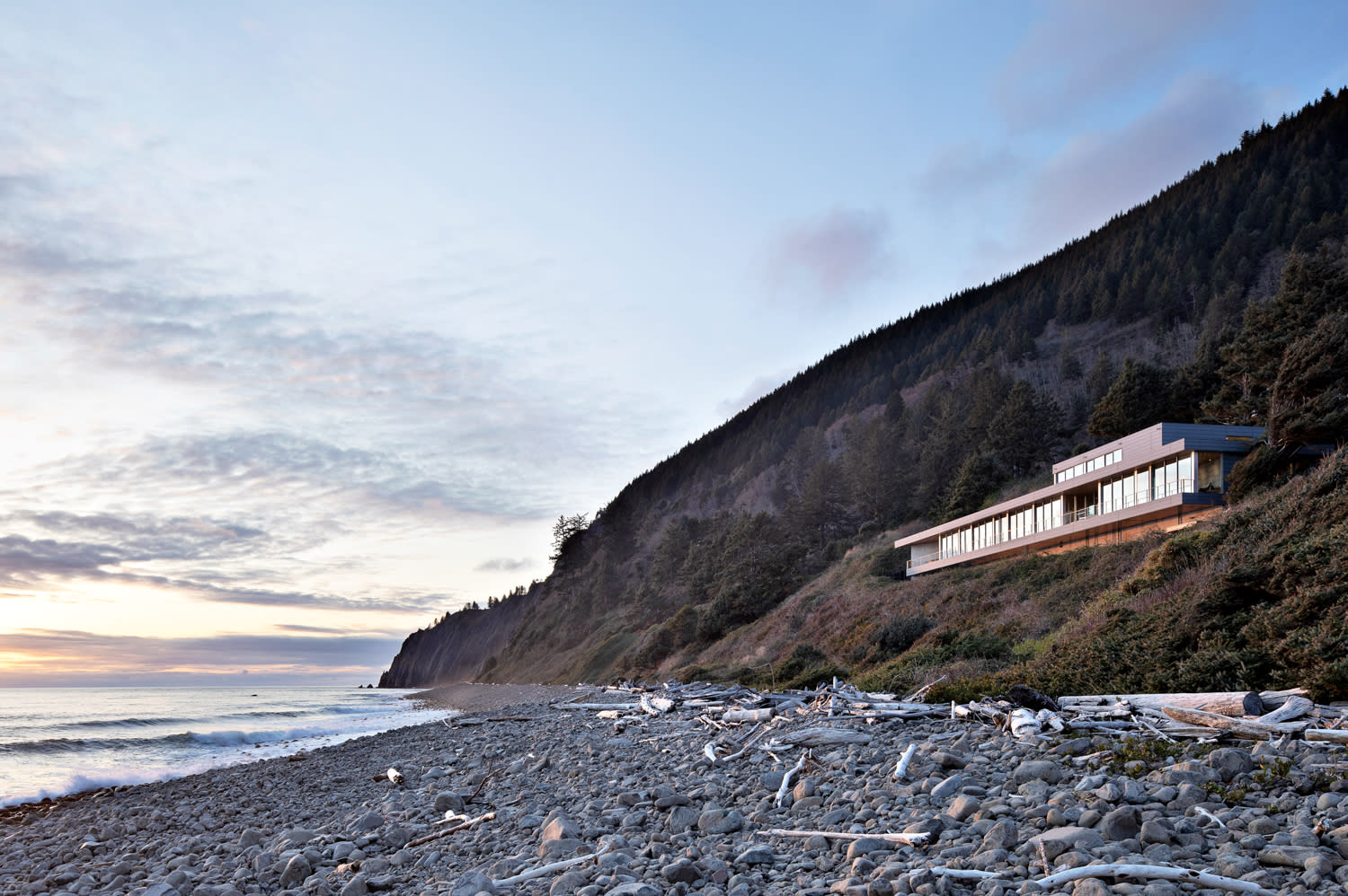 modern home on cliff with view of rocky beach and ocean