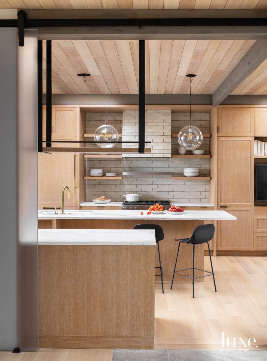 kitchen with tbrick backsplash and two islands