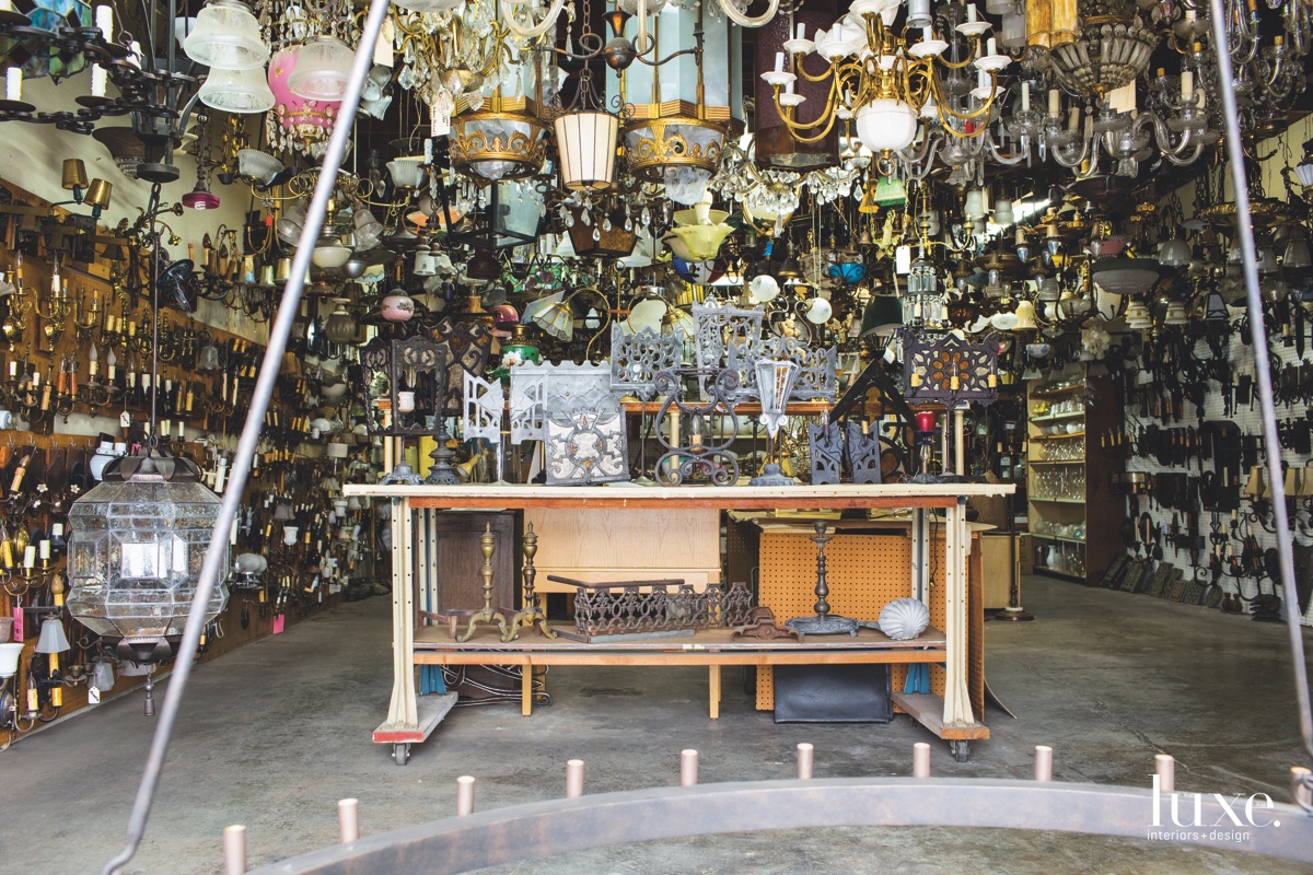 Dozens of vintage light fixtures hang in Gibson's studio. He's often called on to recreate antique pieces.