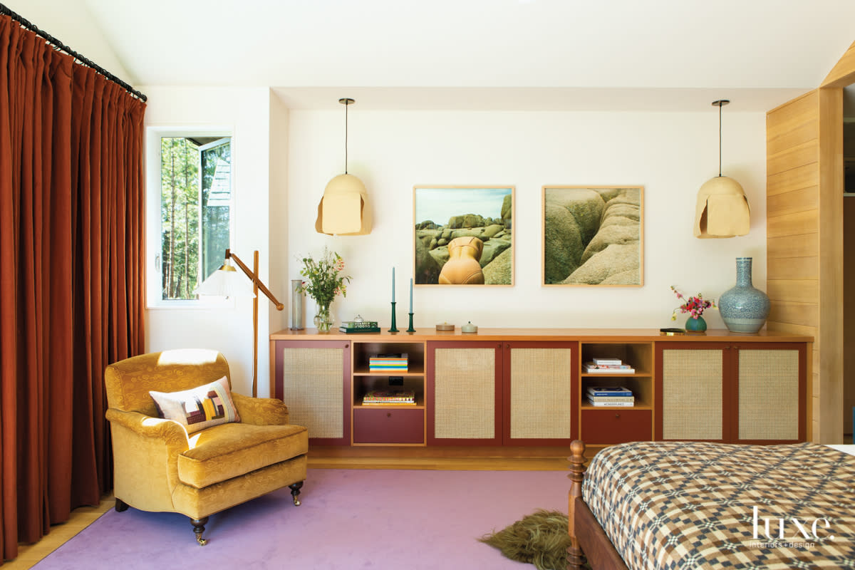 Master bedroom with purple carpet, yellow chair and built in