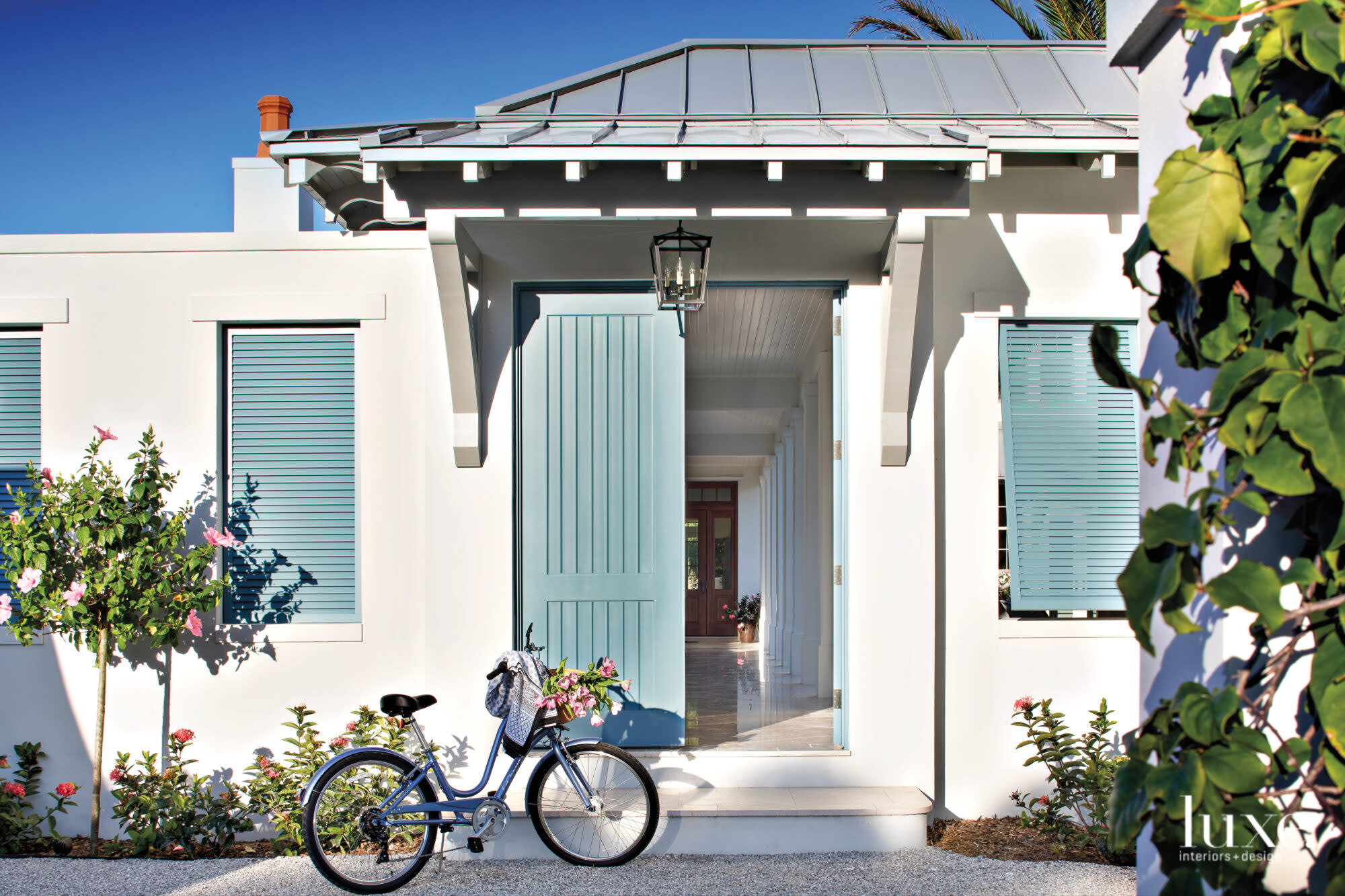 Exterior of a house with blue door and shutters