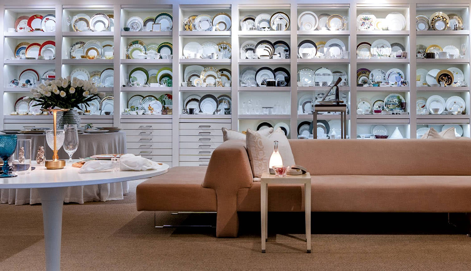 A showroom filled with shelves of dishes in different shapes, sizes and colors.