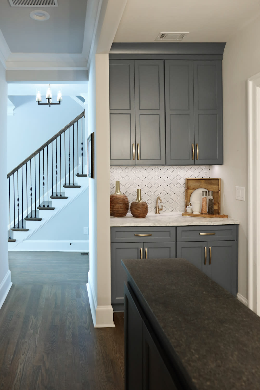 blue cabinets with white tile backsplash on a coffee bar in home with wood floors by Construction Resources in Georgia