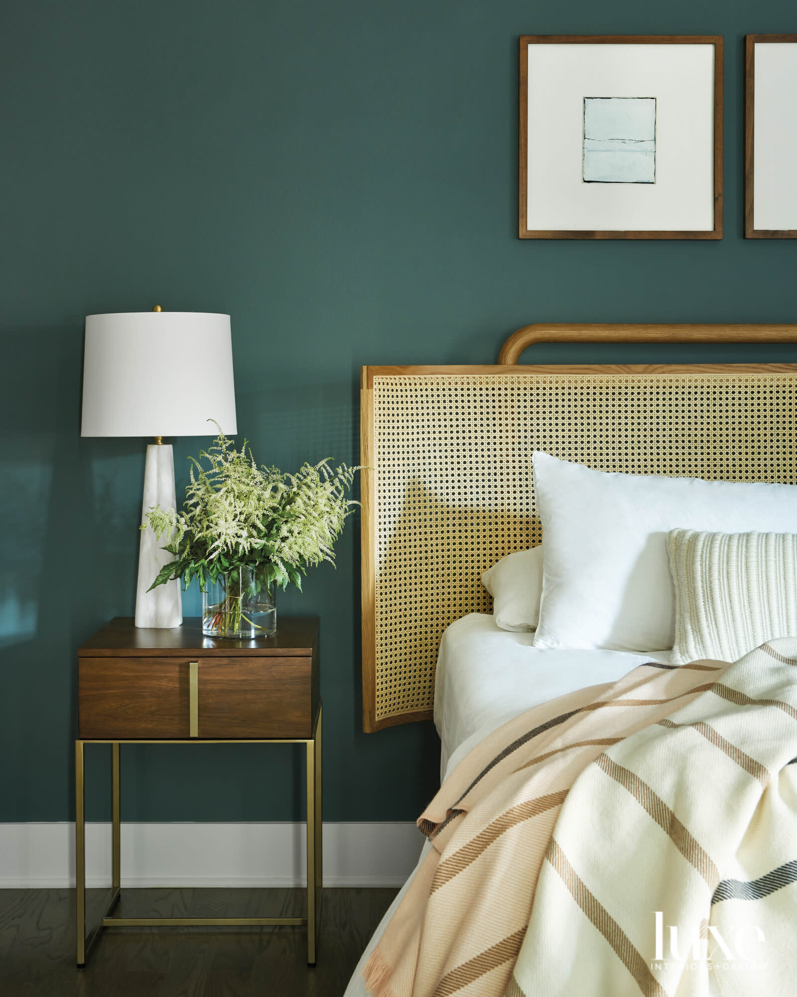 A cane bed in the main bedroom, which has green walls.