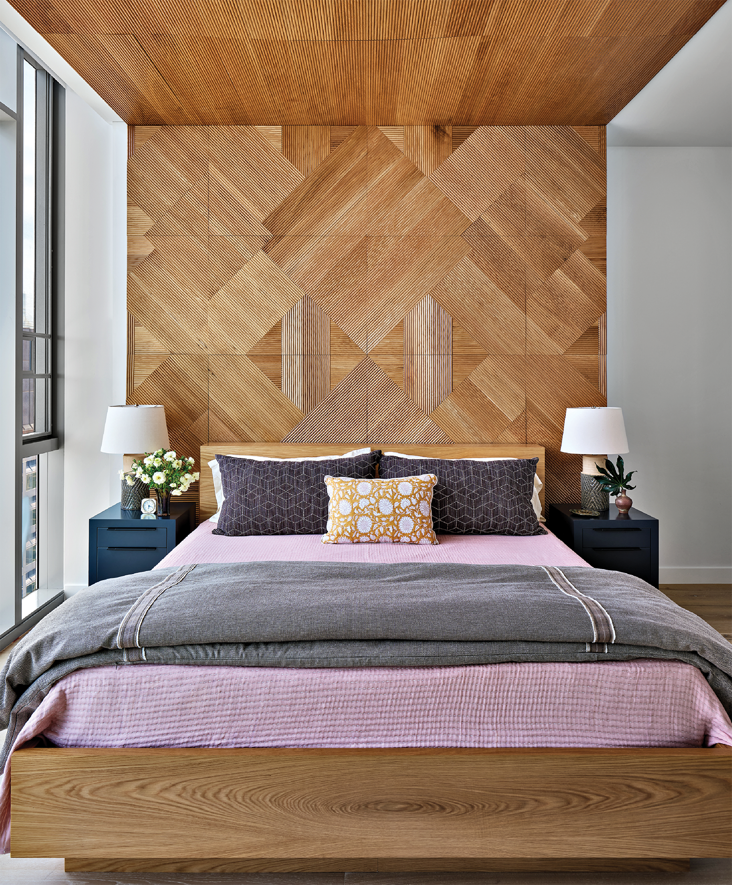modern bedroom with a reeded wood panel in an asymmetrical pattern on the wall above the bed