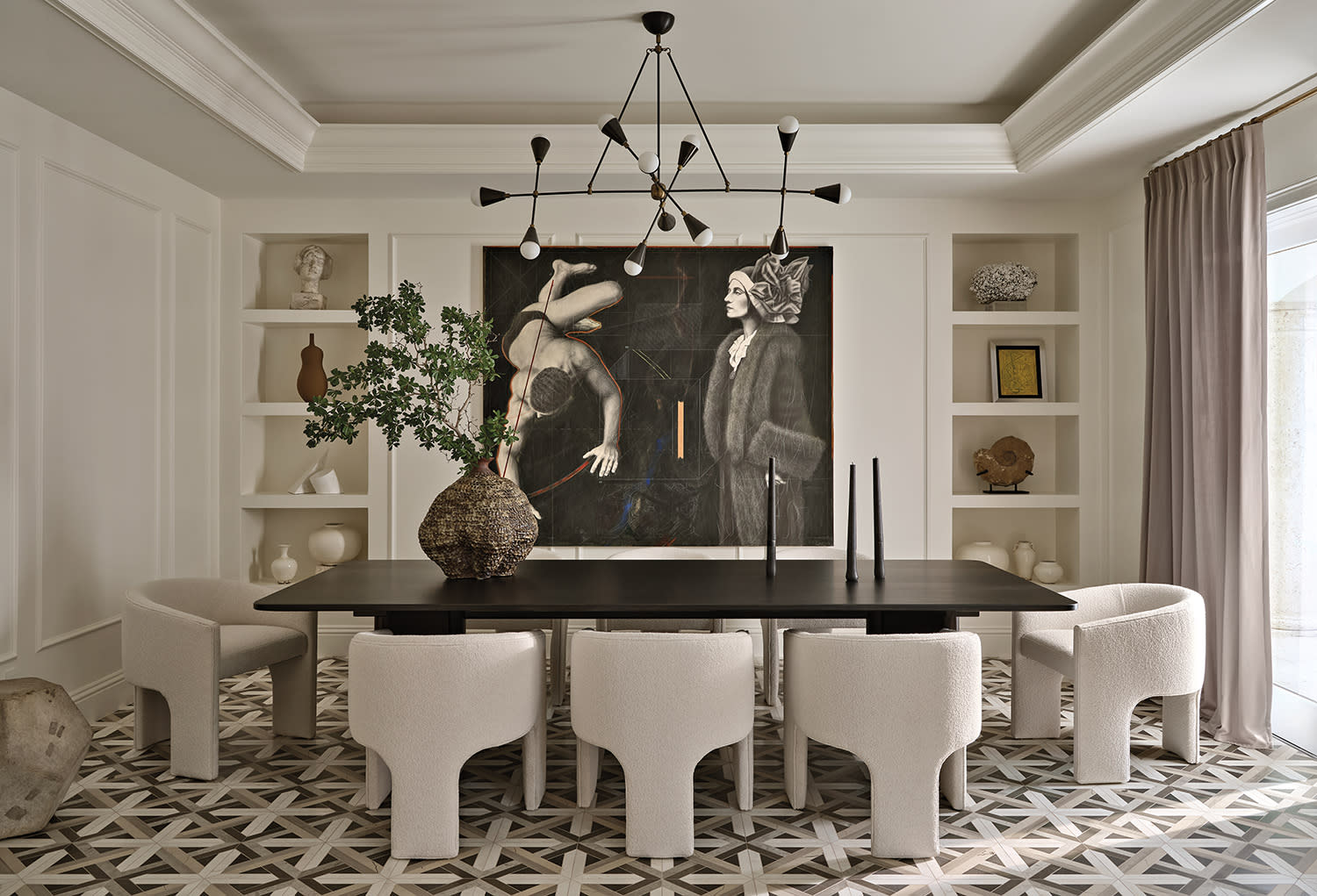 Elegant dining room with geometric flooring, a dark wood table, and six plush white chairs.