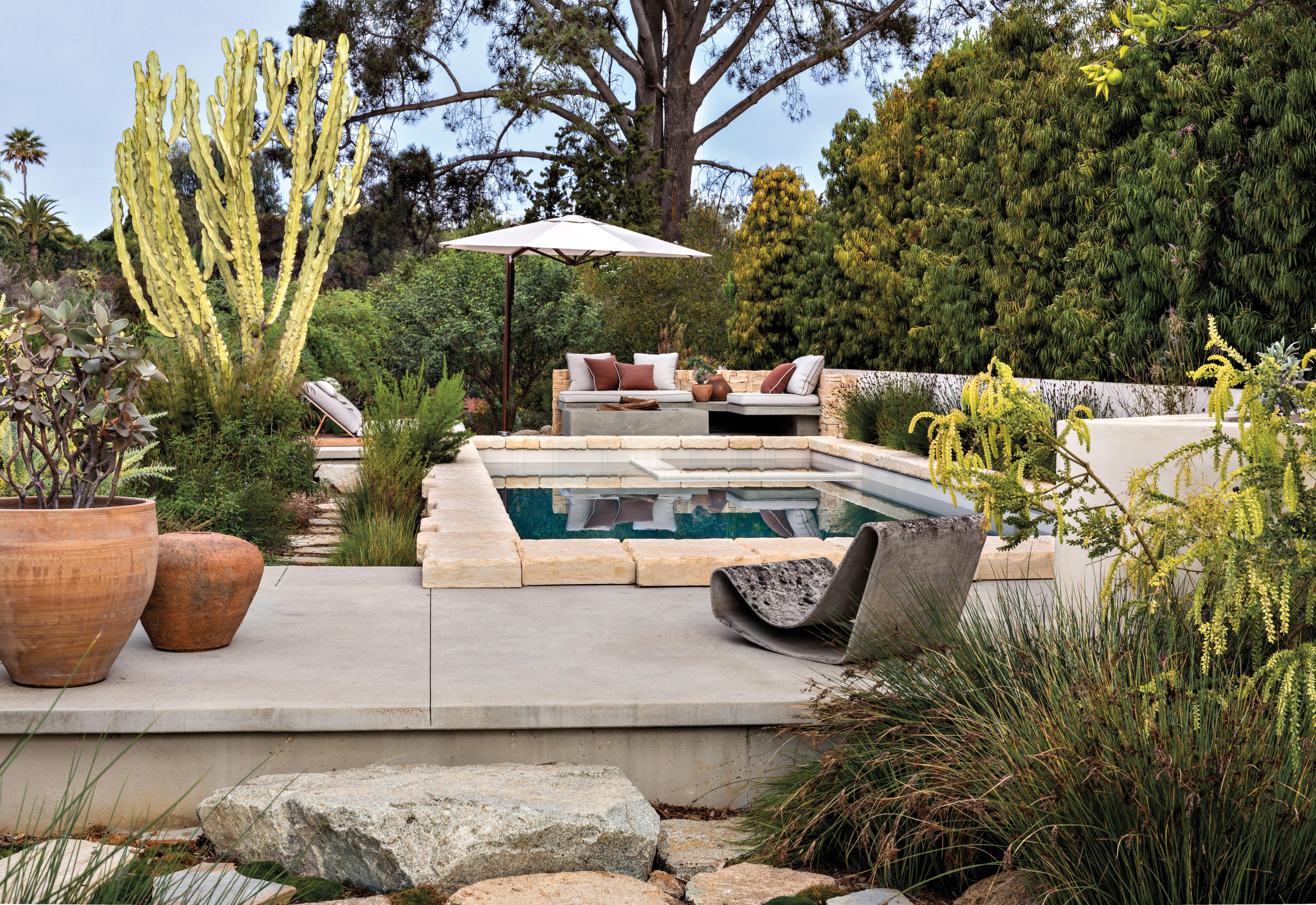 pool surrounded by a patio and lush vegetation in southern California