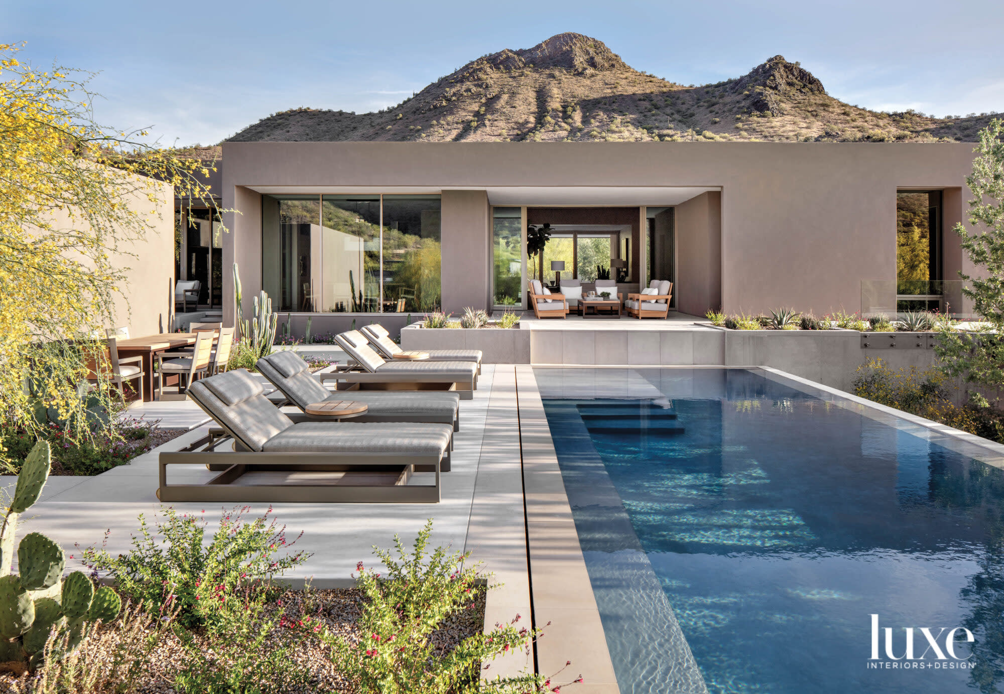 An infinity pool with lounge chairs next to it.