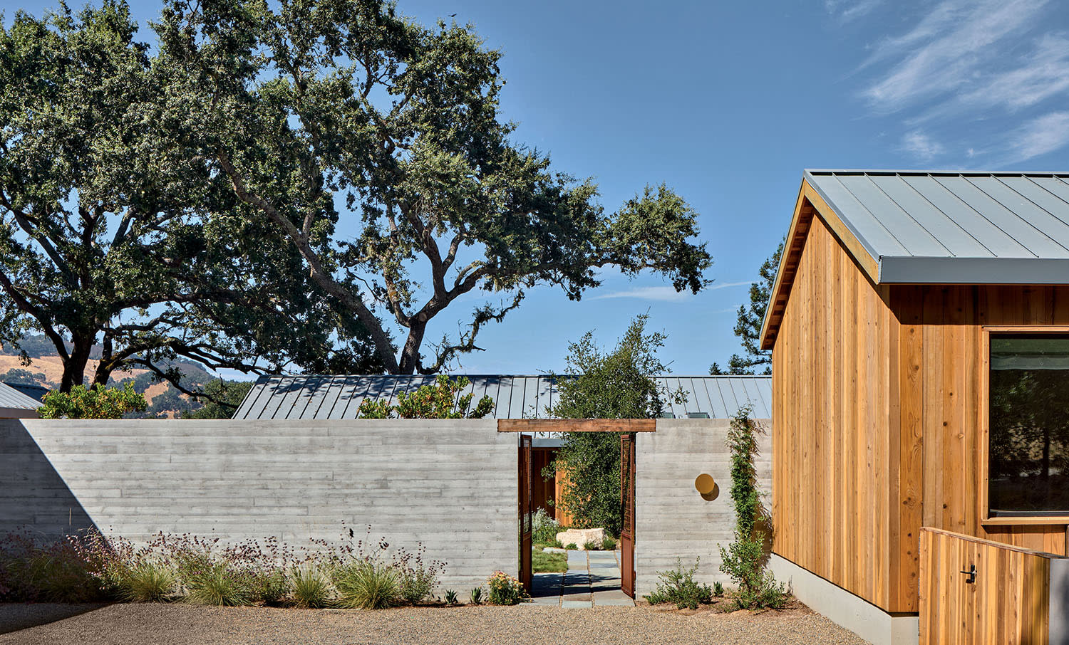 home exterior made of redwood siding with a metal roof