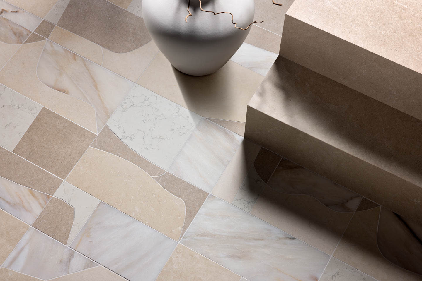 A white vase sits on a geometric-patterned beige and white tile floor next to stone steps, creating a minimalist, modern ambiance.