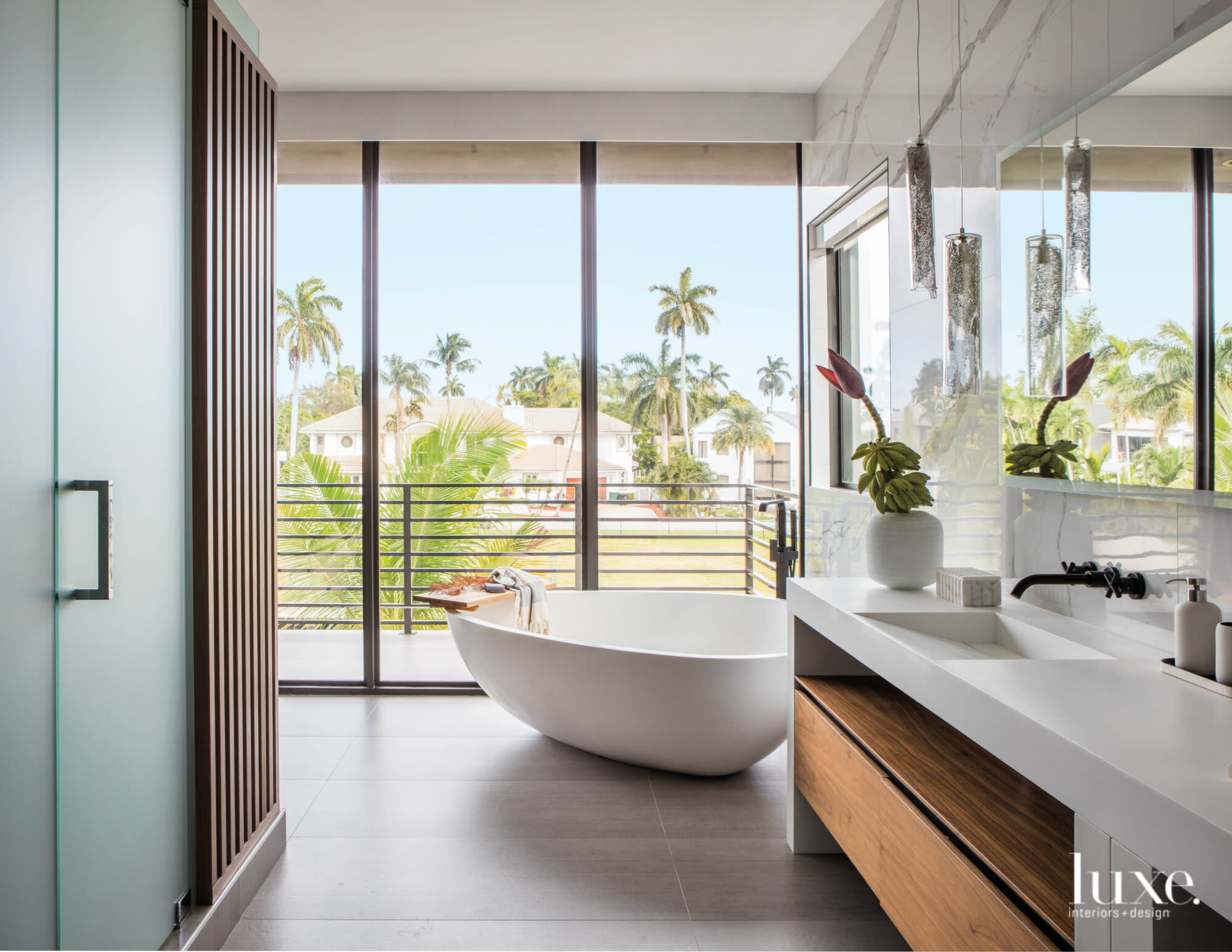 Bathroom with freestanding tub and walnut shower screen.