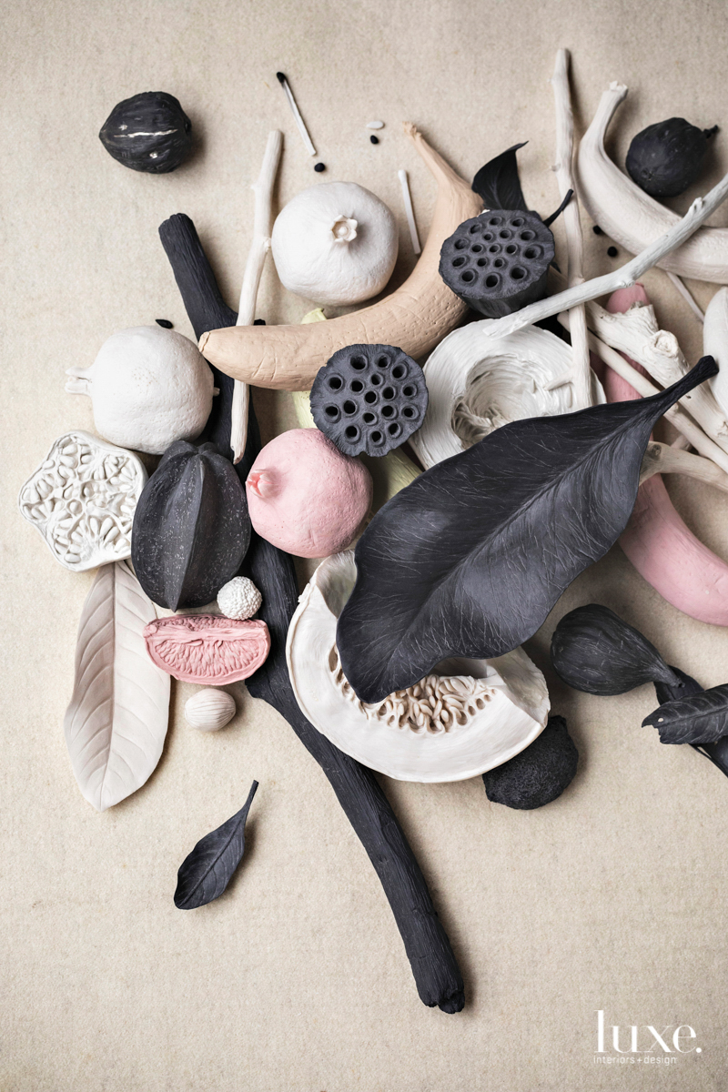 a pile of fruits, leaves and sticks made of porcelain